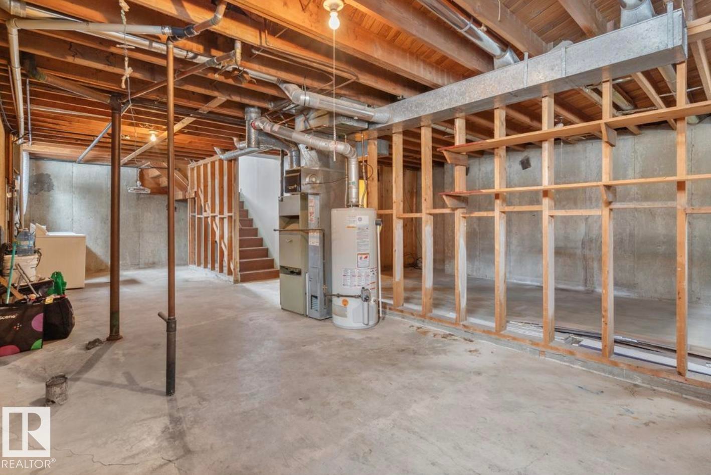 Unfinished basement featuring water heater, stairway, and heating unit - 3810 110 Avenue, Edmonton, AB - Indoor Photo Showing Basement