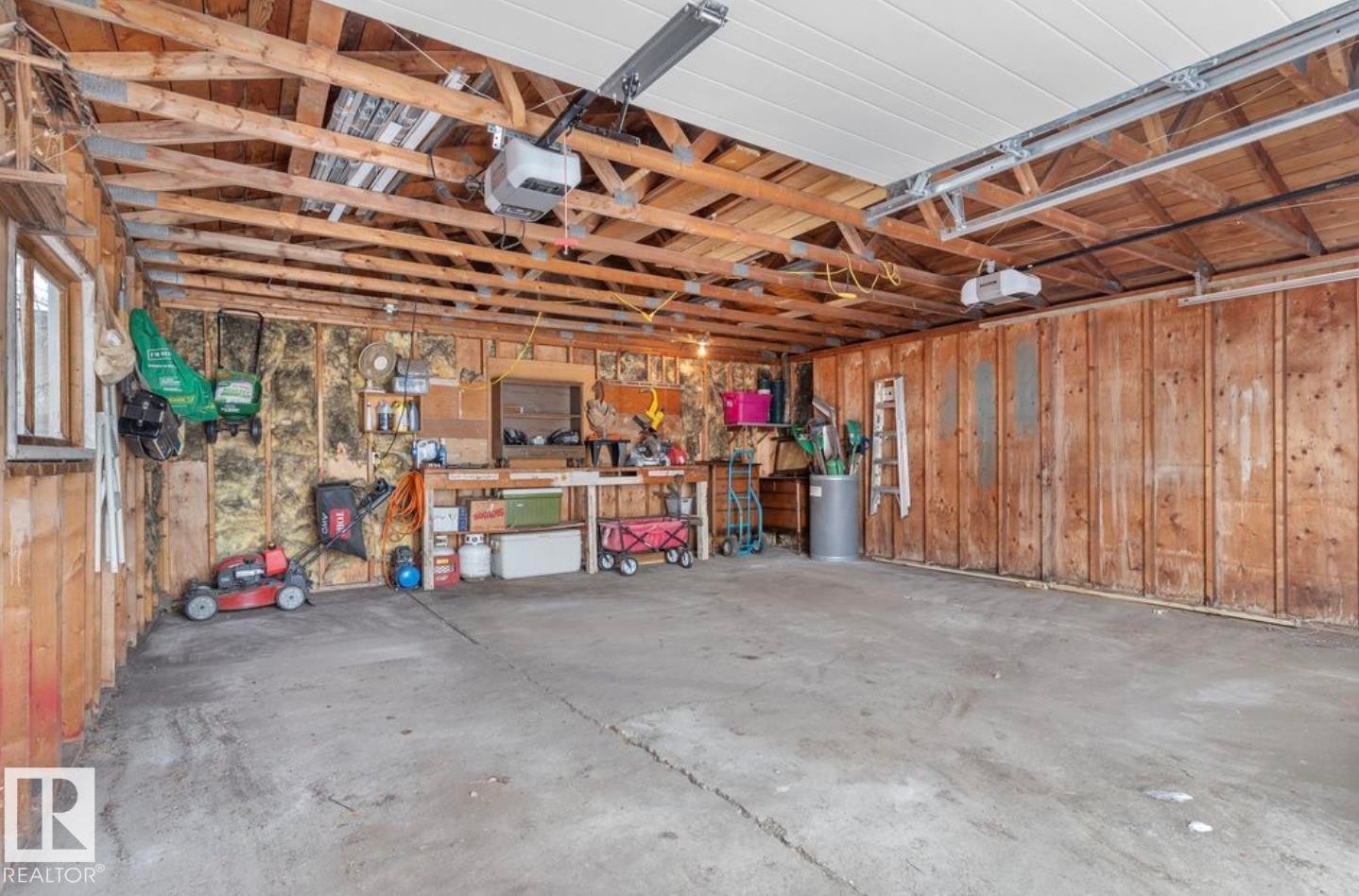 Garage with wooden walls and a garage door opener - 3810 110 Avenue, Edmonton, AB - Indoor Photo Showing Garage