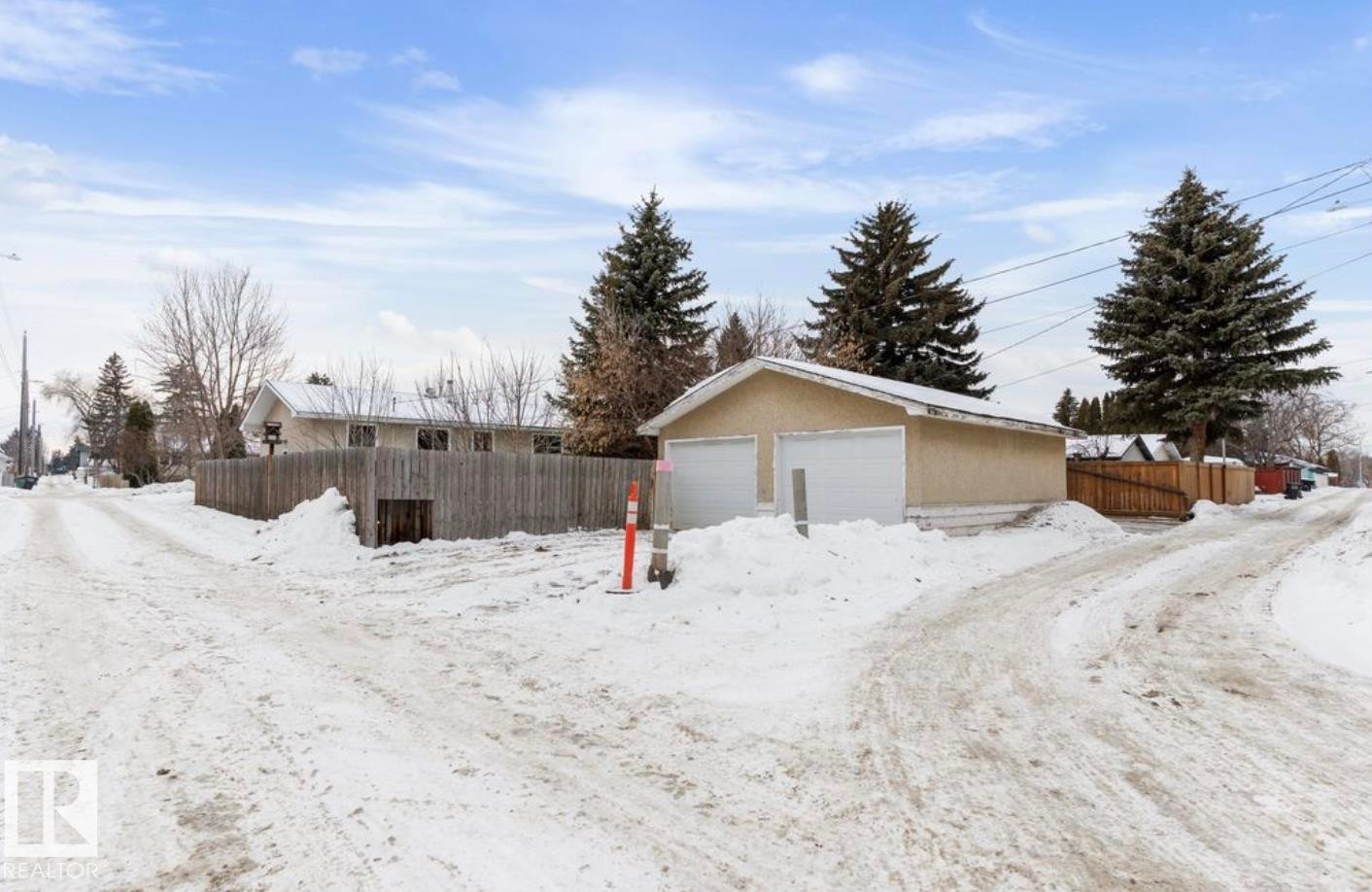 Yard layered in snow with an outdoor structure and a detached garage - 3810 110 Avenue, Edmonton, AB - Outdoor