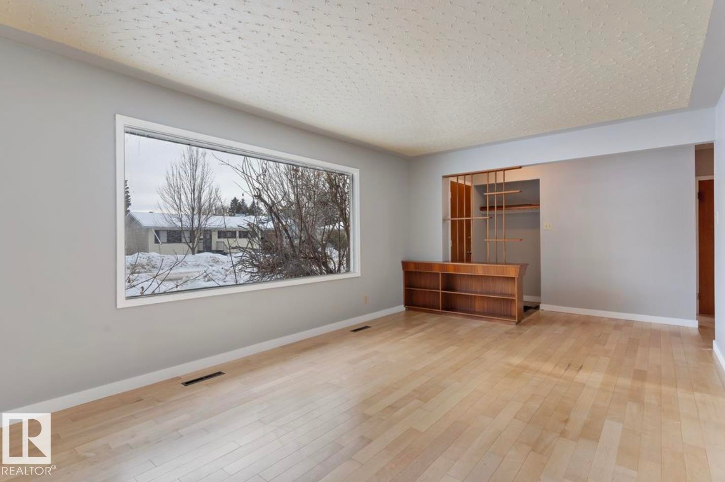 Unfurnished bedroom with light wood-type flooring and a textured ceiling - 3810 110 Avenue, Edmonton, AB - Indoor