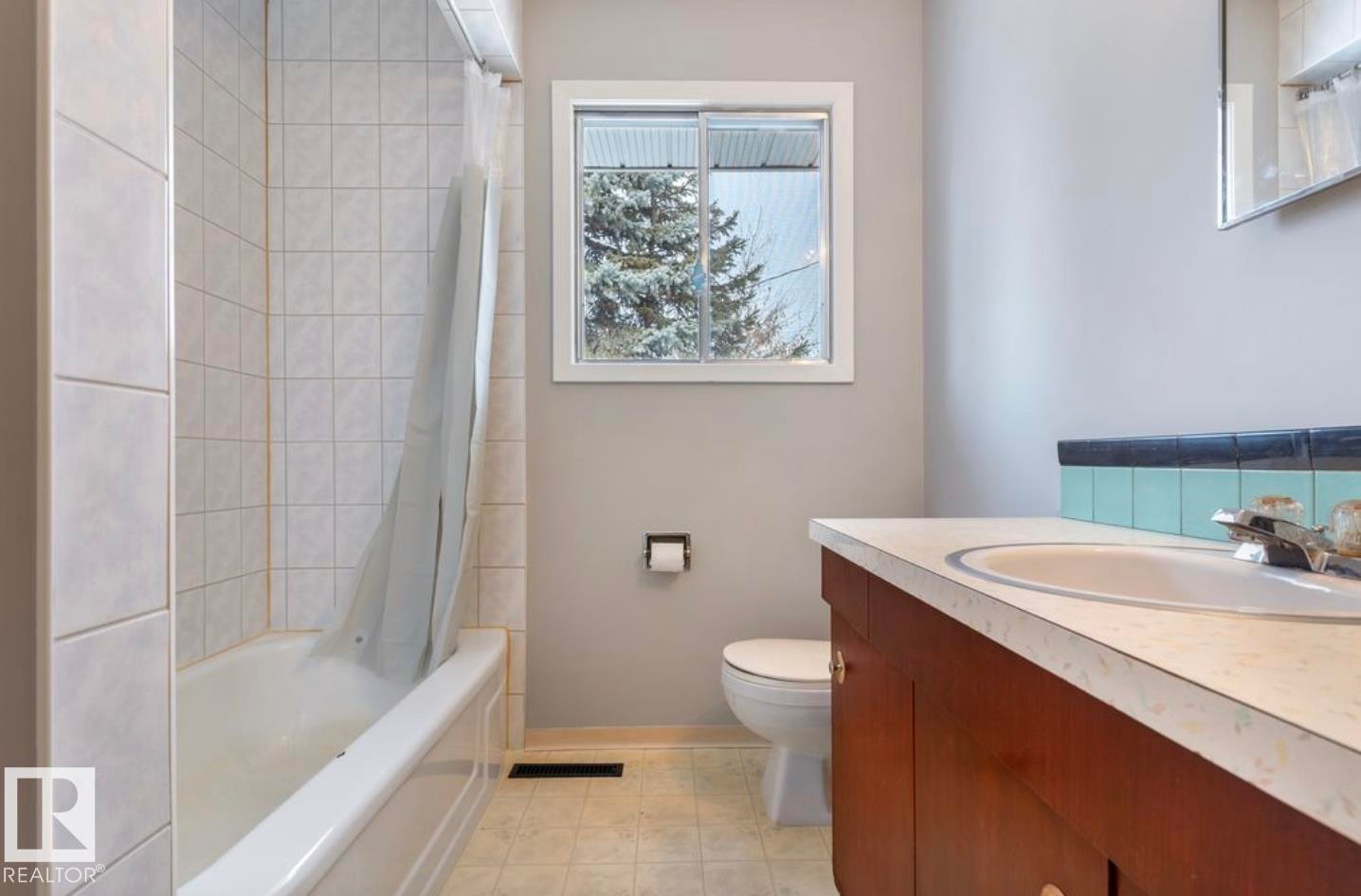 Bathroom featuring vanity and shower / bath combination with curtain - 3810 110 Avenue, Edmonton, AB - Indoor Photo Showing Bathroom