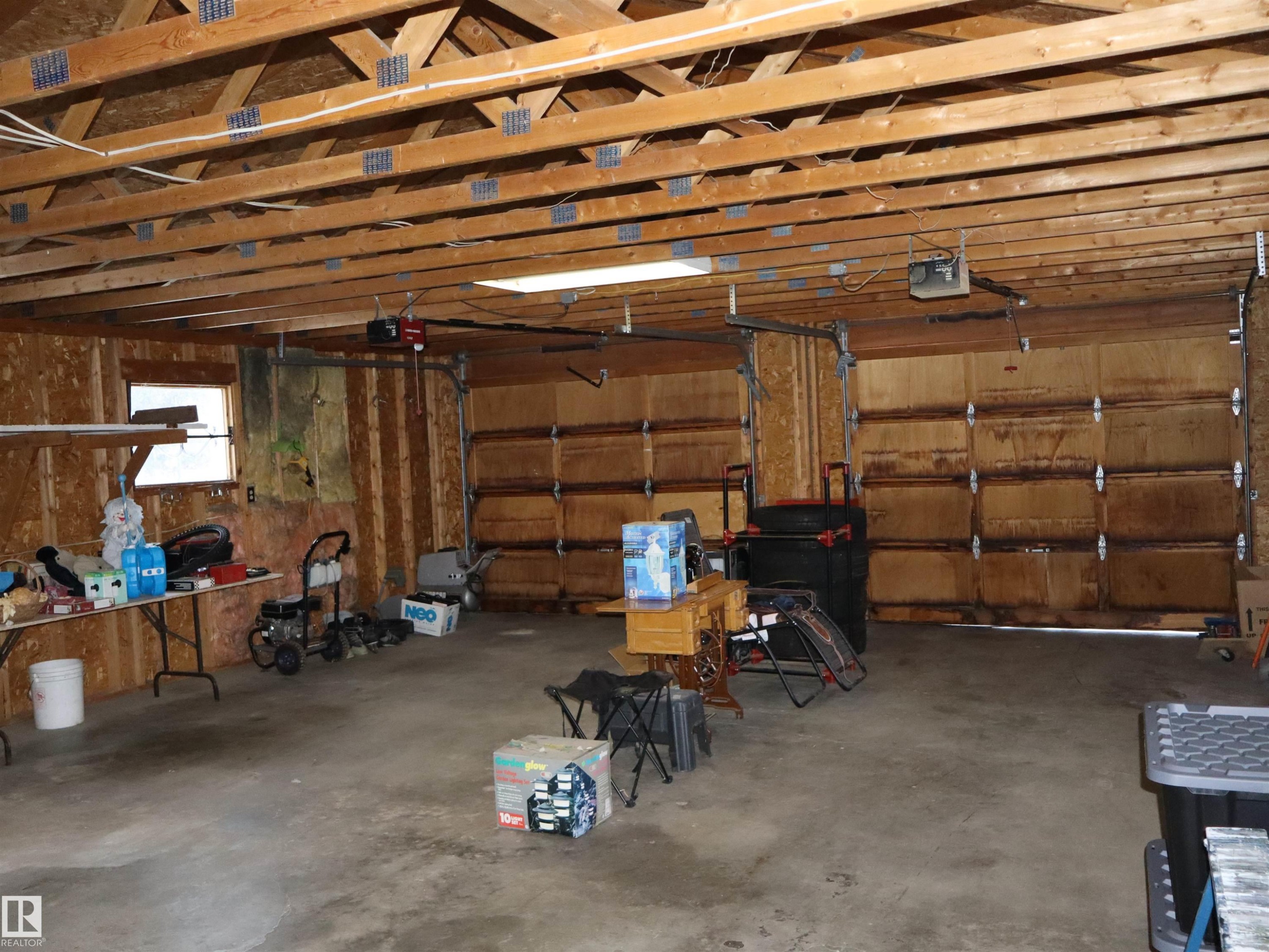 Garage with a garage door opener - 4511 53 Ave, Barrhead, AB - Indoor Photo Showing Garage