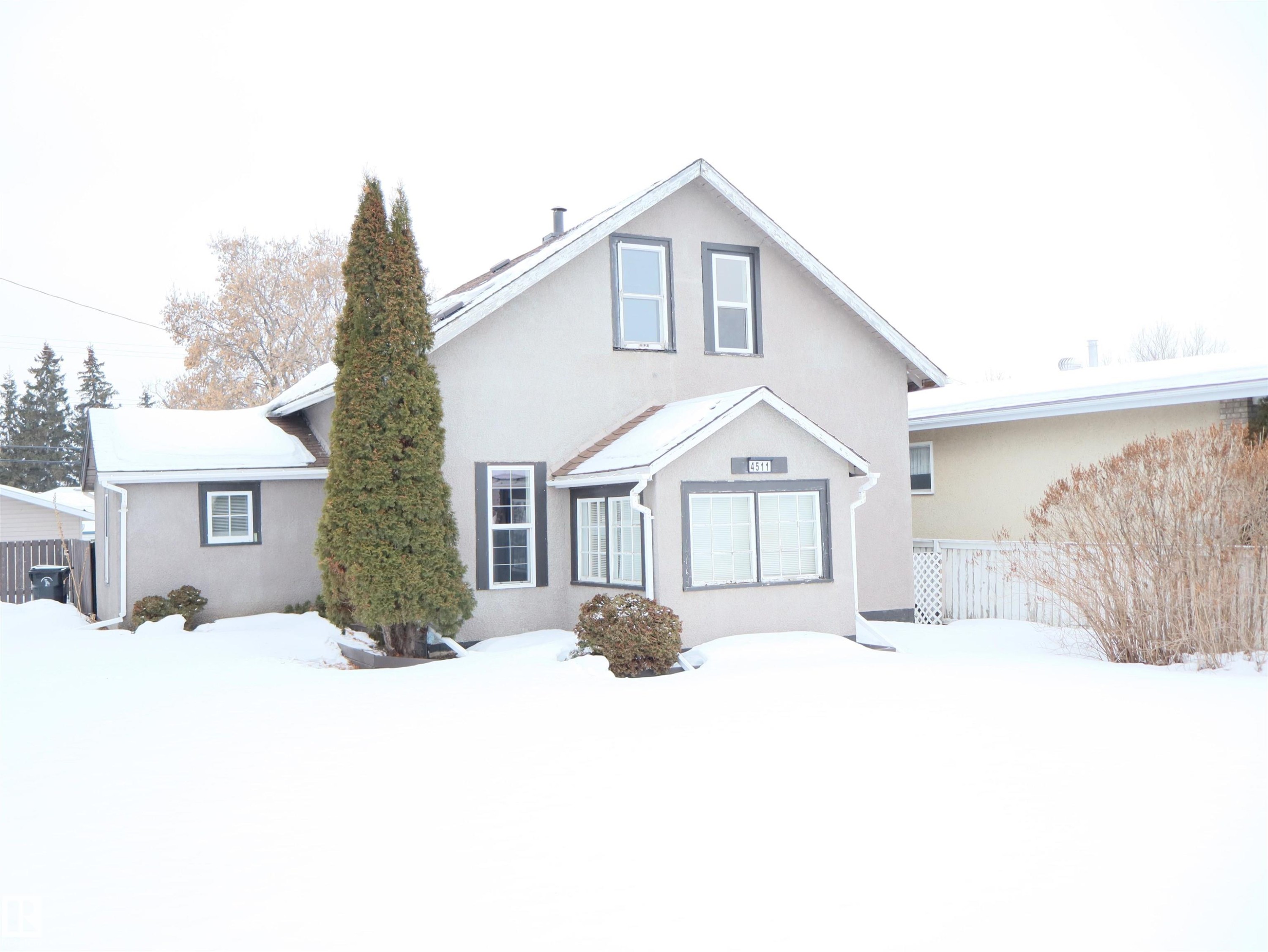 View of front of house featuring stucco siding - 4511 53 Ave, Barrhead, AB - Outdoor