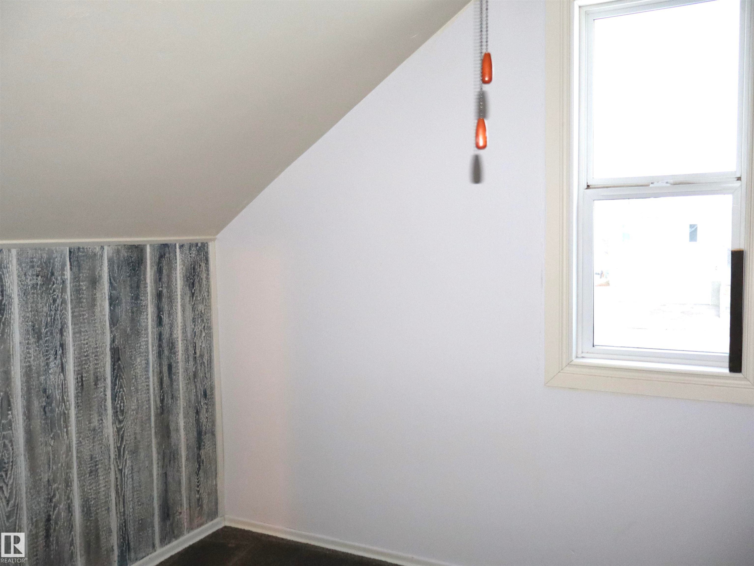 Spare room featuring healthy amount of natural light and lofted ceiling - 4511 53 Ave, Barrhead, AB - Indoor Photo Showing Other Room