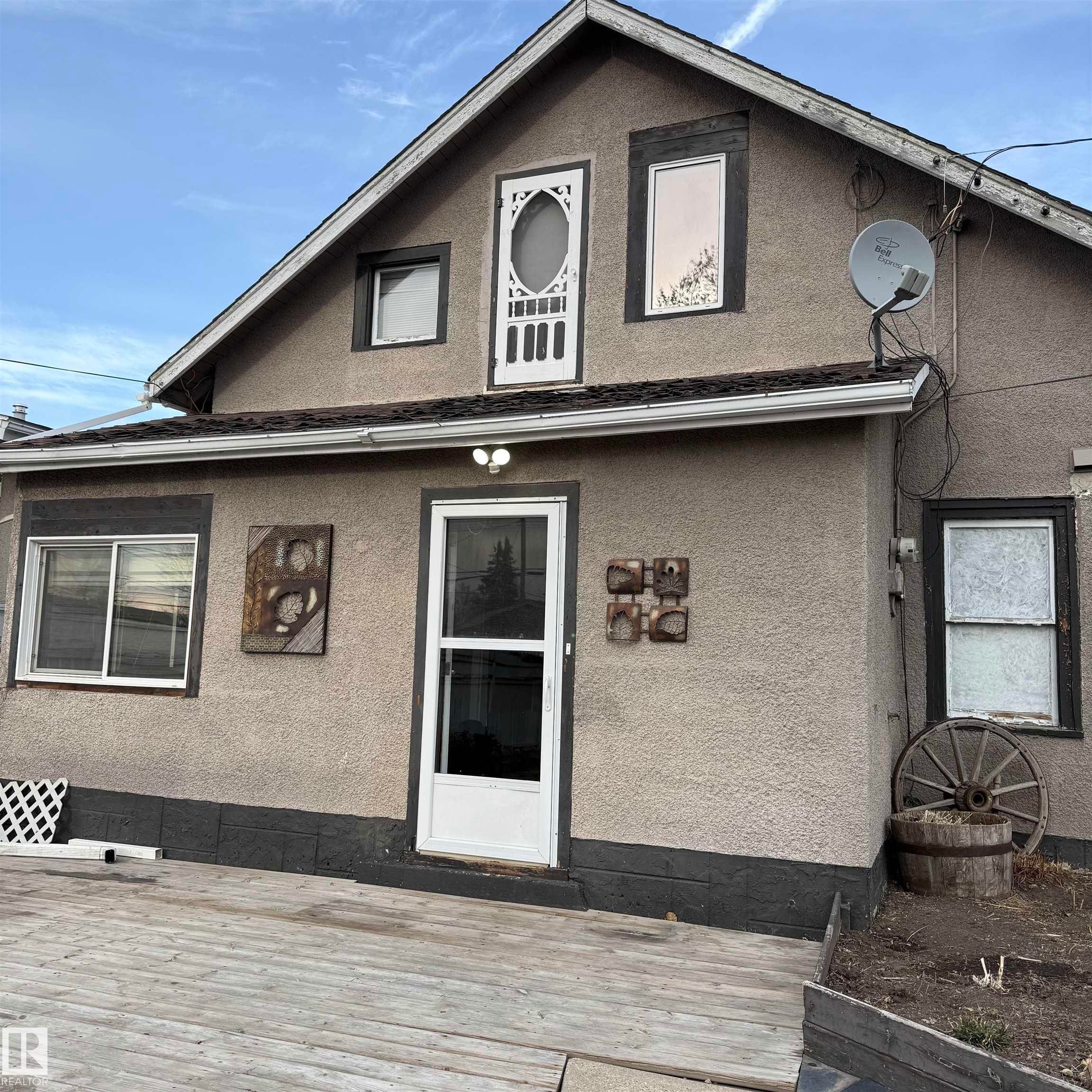 Back of property with stucco siding - 4511 53 Ave, Barrhead, AB - Outdoor With Exterior