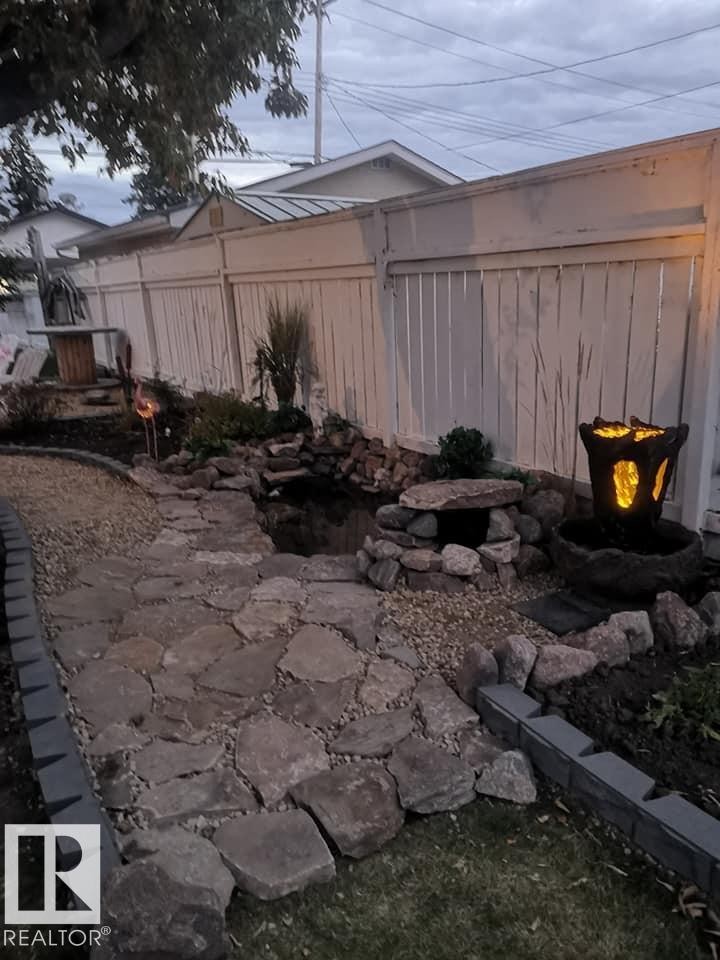 View of fenced backyard - 4511 53 Ave, Barrhead, AB - Outdoor