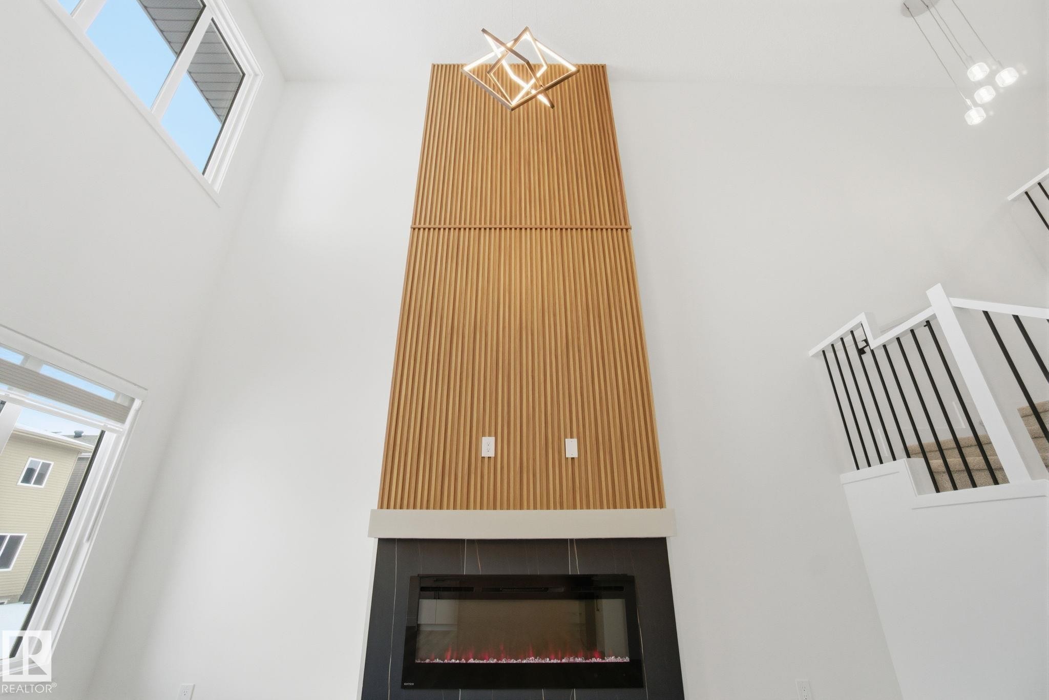 Detailed view of a glass covered fireplace - 2532 210 Street, Edmonton, AB - Indoor Photo Showing Other Room With Fireplace