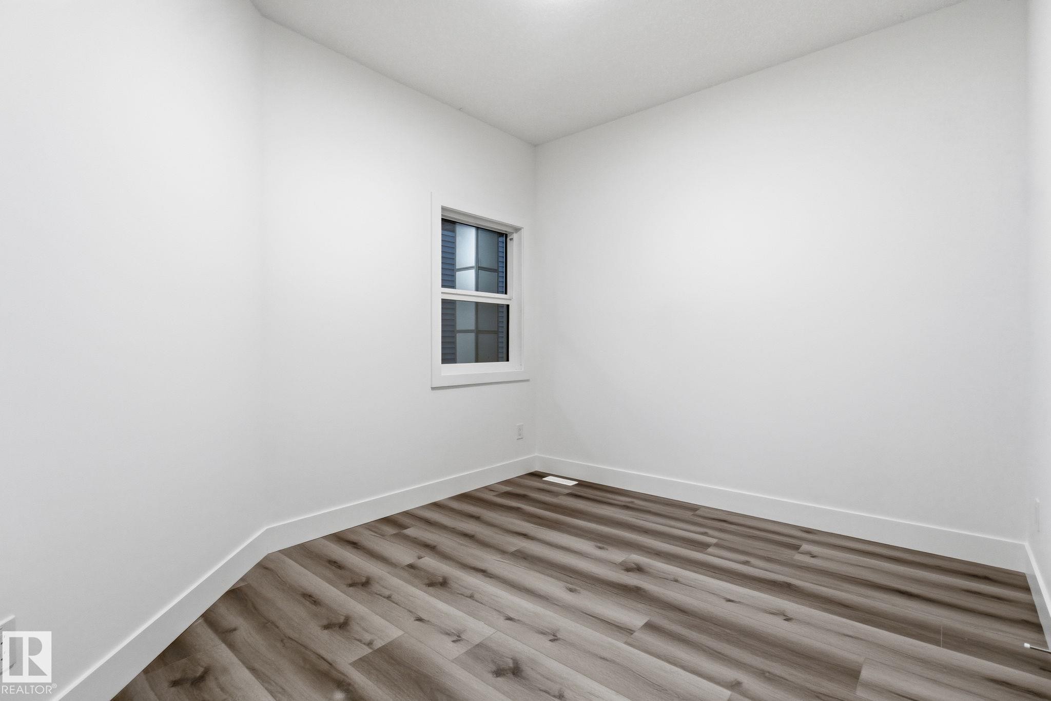 Unfurnished room with wood finished floors and baseboards - 2532 210 Street, Edmonton, AB - Indoor Photo Showing Other Room