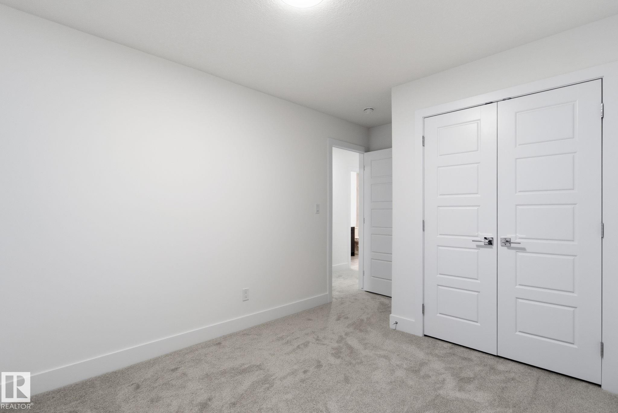 Unfurnished bedroom featuring light colored carpet and a closet - 2532 210 Street, Edmonton, AB - Indoor Photo Showing Other Room