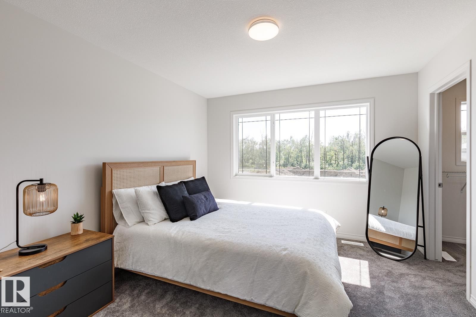 Carpeted bedroom featuring baseboards - 3617 Triomphe Boulevard, Beaumont, AB - Indoor Photo Showing Bedroom