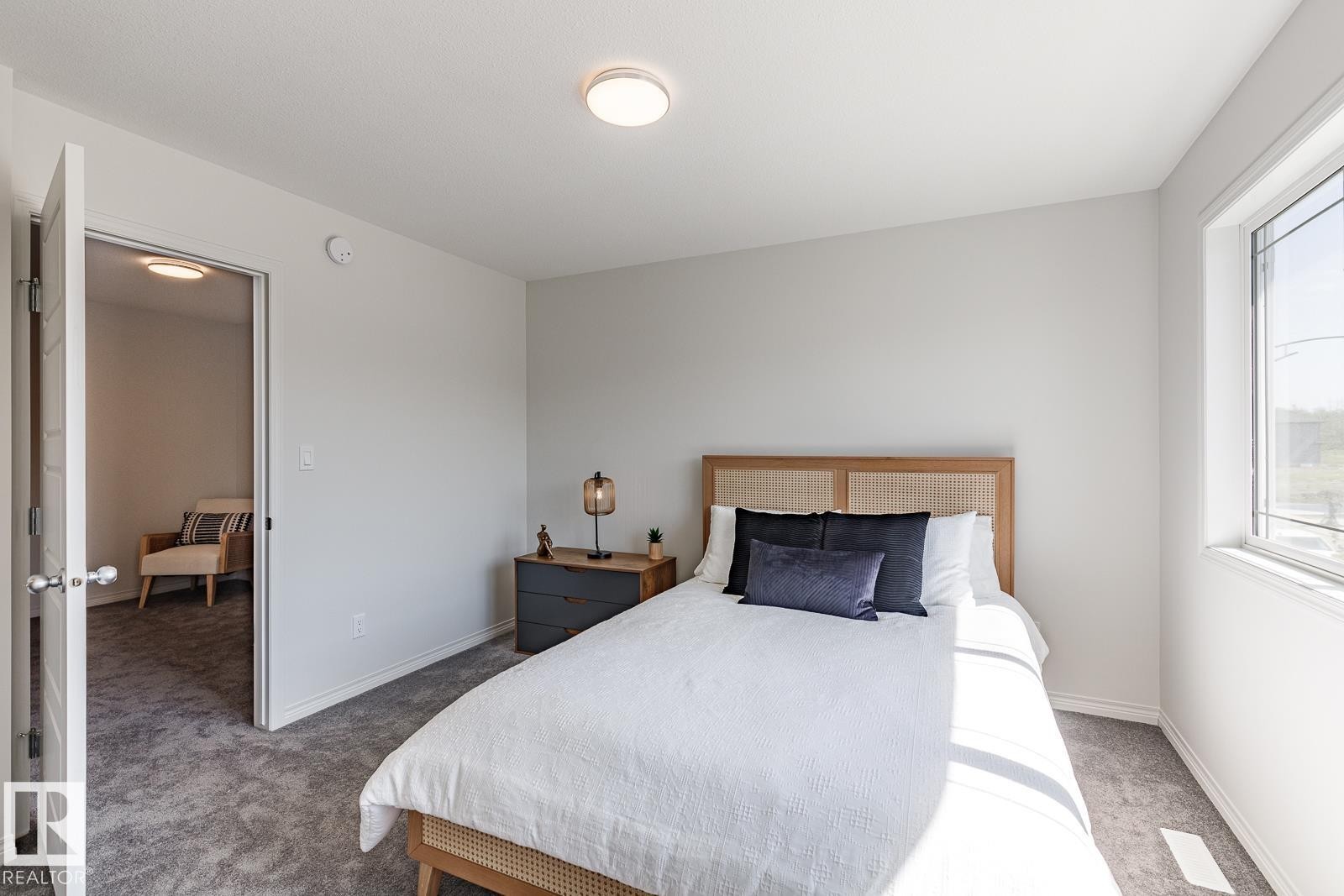 Carpeted bedroom with baseboards - 3617 Triomphe Boulevard, Beaumont, AB - Indoor Photo Showing Bedroom