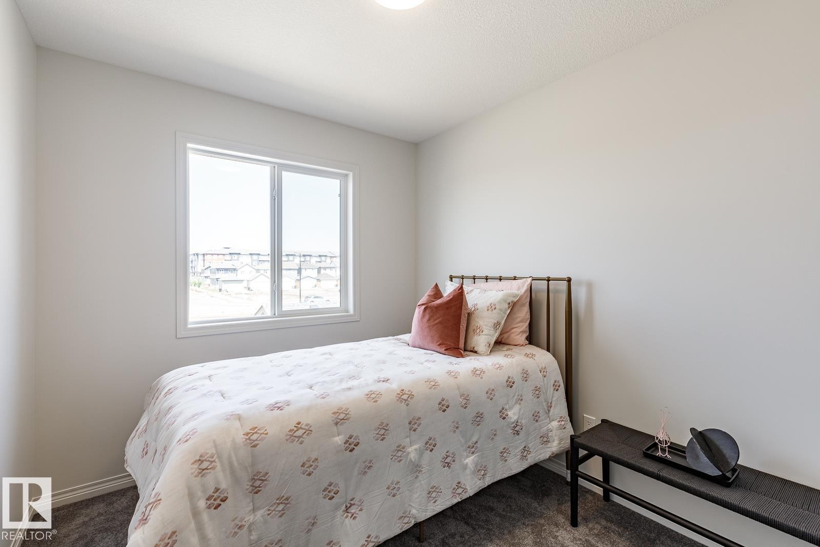 Bedroom with carpet flooring - 3617 Triomphe Boulevard, Beaumont, AB - Indoor Photo Showing Bedroom