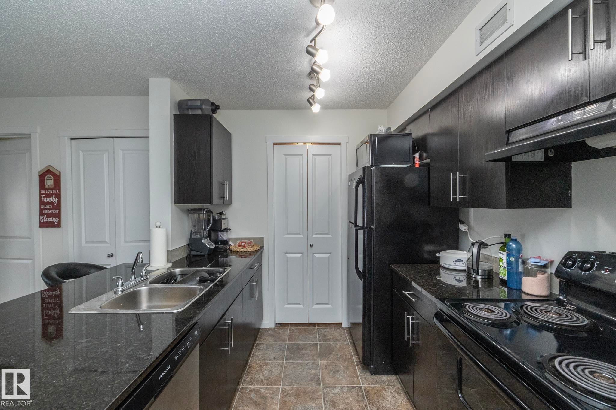 215 5810 Mullen Place, Edmonton, AB - Indoor Photo Showing Kitchen With Double Sink