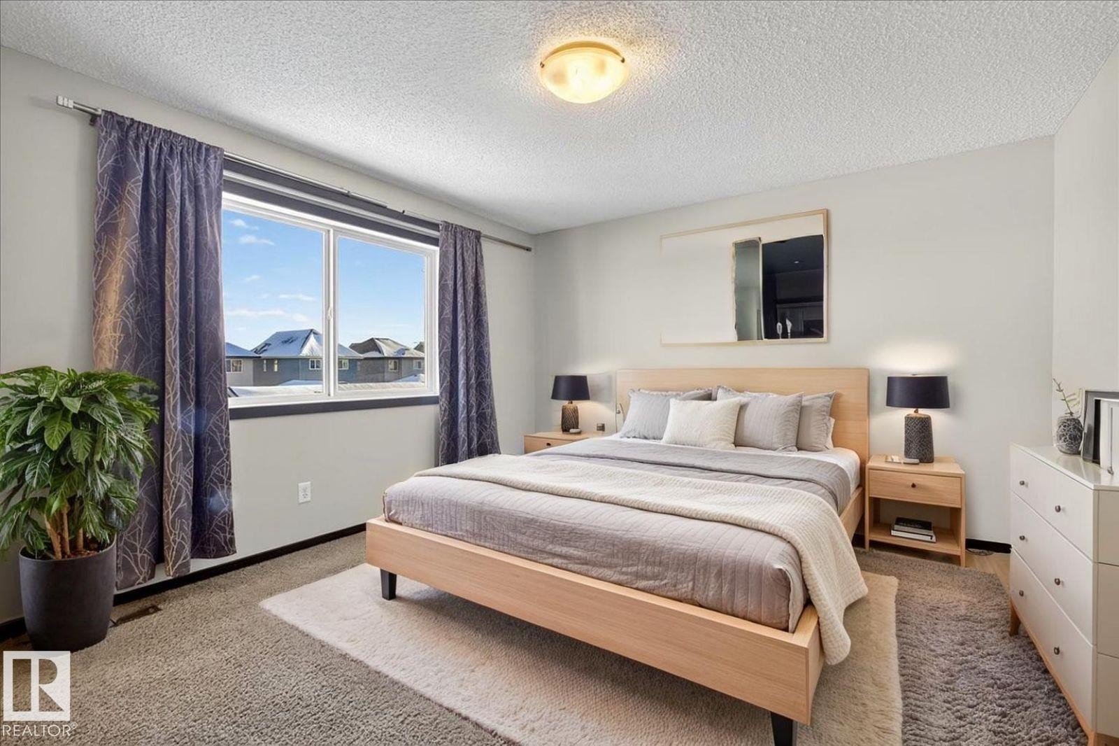Bedroom with a textured ceiling and carpet floors - 3623 13 Street, Edmonton, AB - Indoor Photo Showing Bedroom