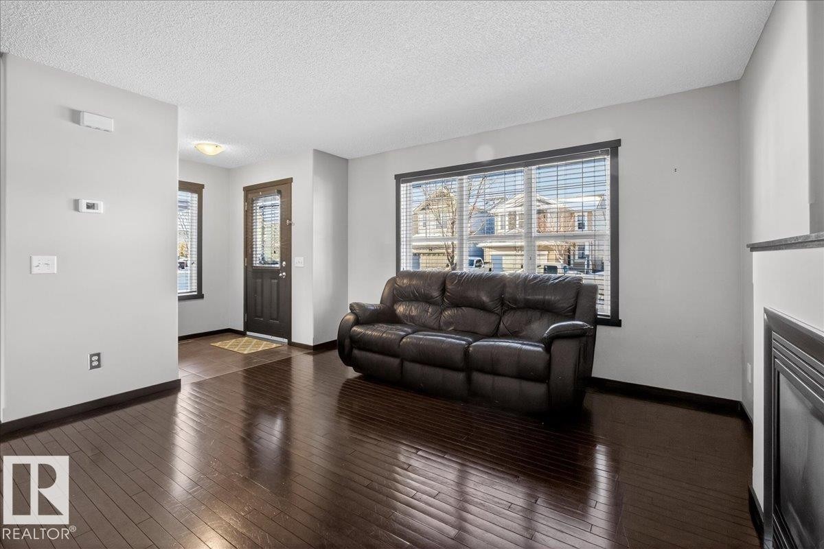Living room with a textured ceiling and dark wood-type flooring - 3623 13 Street, Edmonton, AB - Indoor Photo Showing Living Room