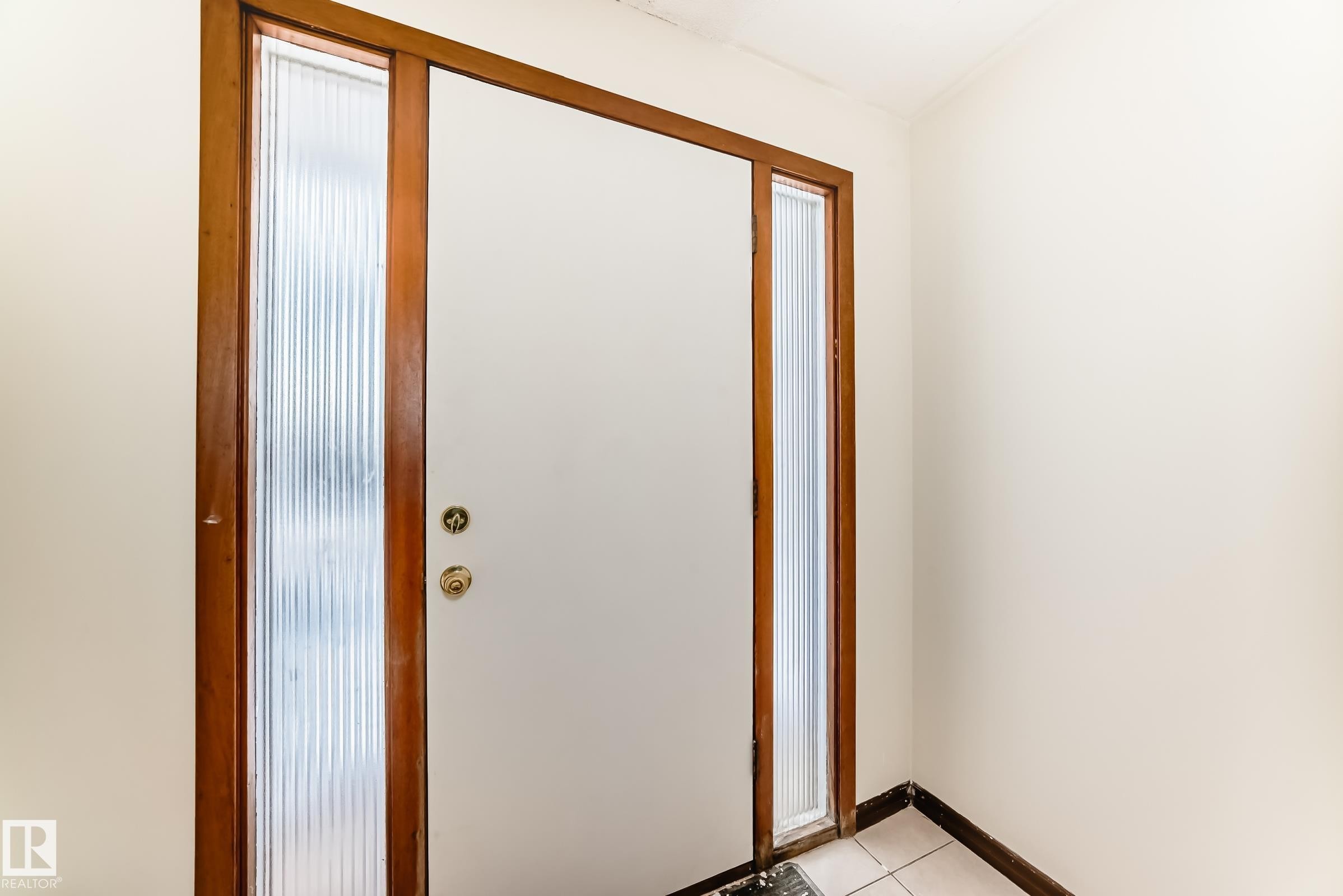Doorway with baseboards and tile patterned floors - 12028 87 Street, Edmonton, AB - Indoor Photo Showing Other Room