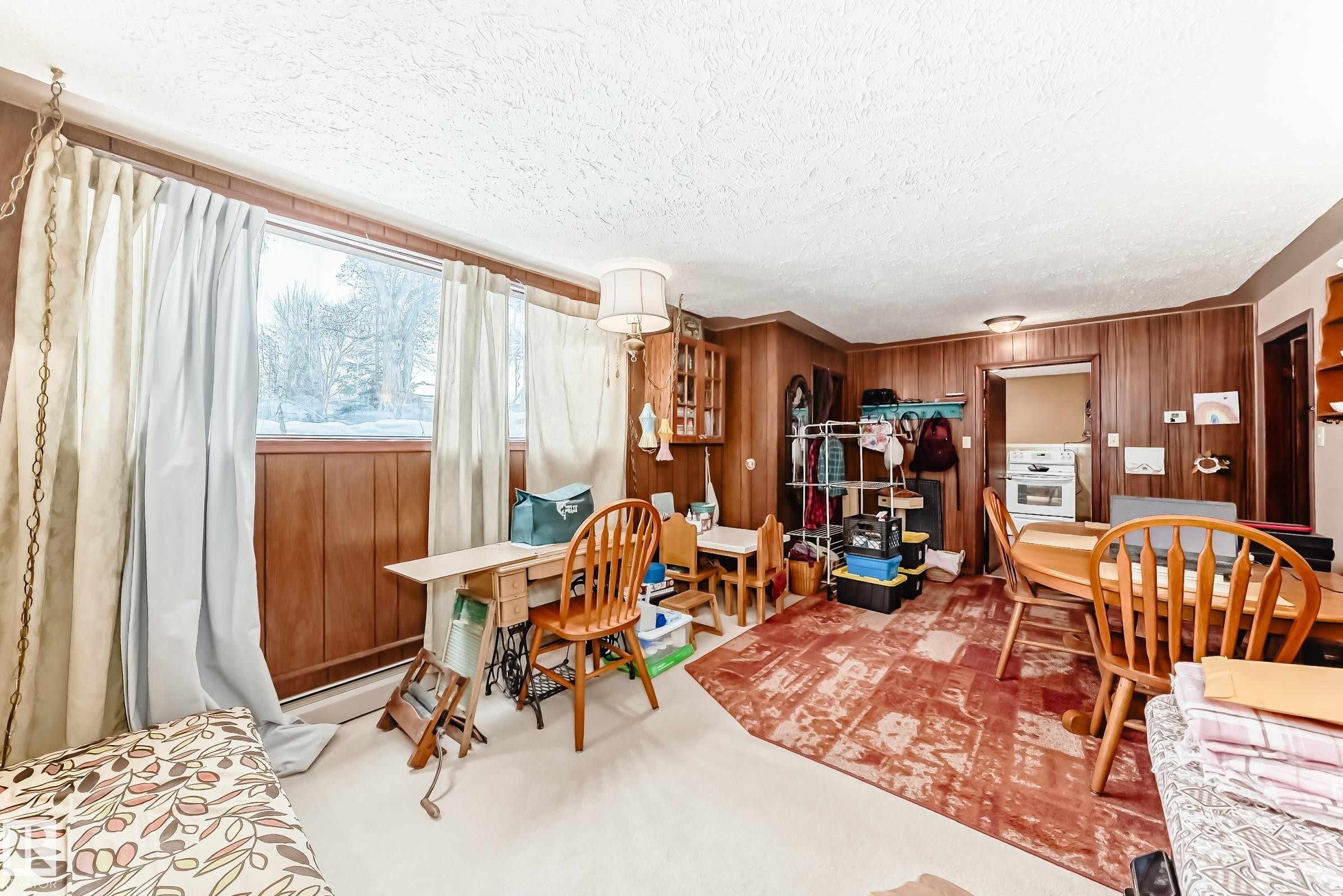 Dining area with wood walls and a textured ceiling - 12028 87 Street, Edmonton, AB - Indoor