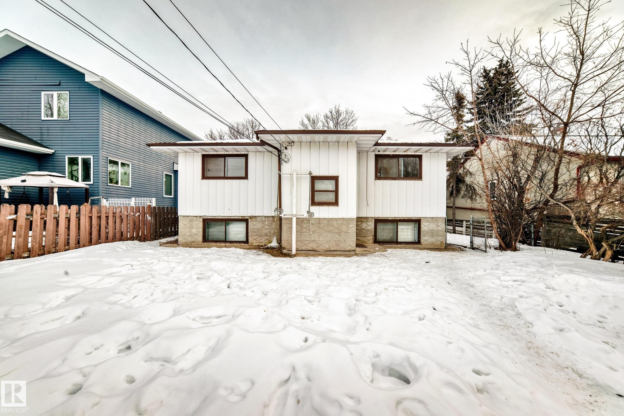 Snow covered back of property with board and batten siding - 12028 87 Street, Edmonton, AB - Outdoor