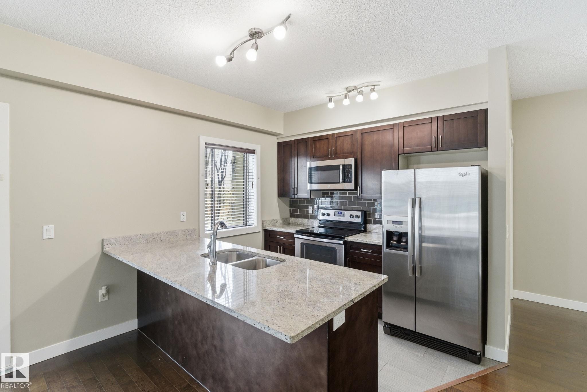 214 1238 Windermere Way, Edmonton, AB - Indoor Photo Showing Kitchen With Stainless Steel Kitchen With Double Sink
