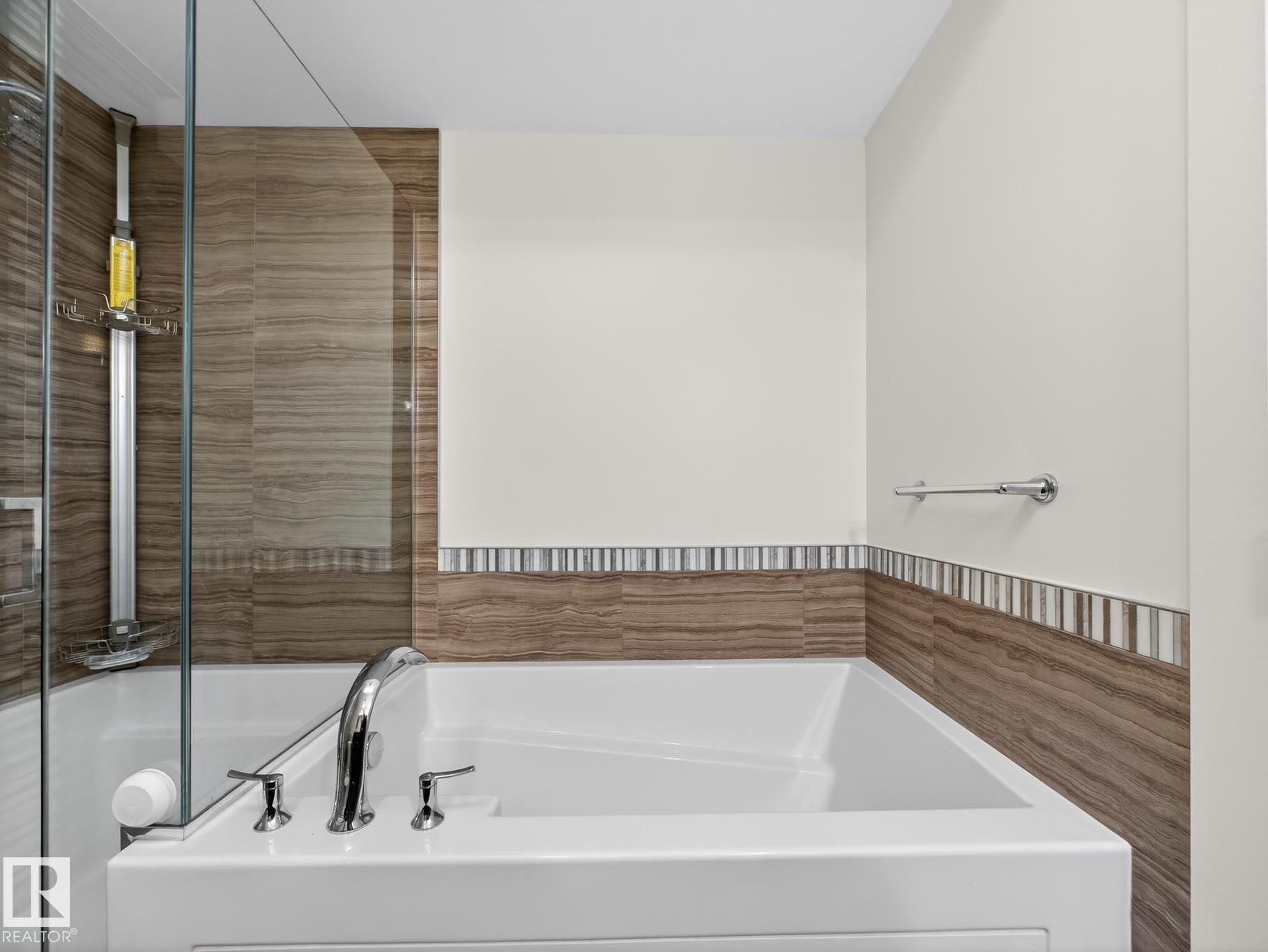 Bathroom featuring a bath and tile walls - #902 11969 Jasper Av Nw, Edmonton, AB - Indoor Photo Showing Bathroom