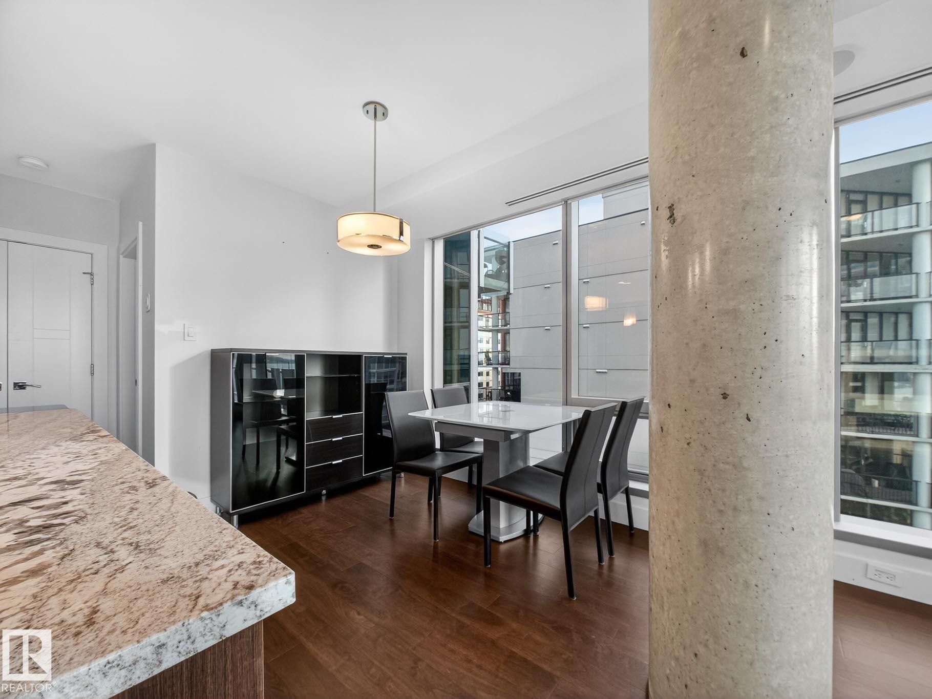 Dining room with dark wood-style floors - #902 11969 Jasper Av Nw, Edmonton, AB - Indoor Photo Showing Dining Room