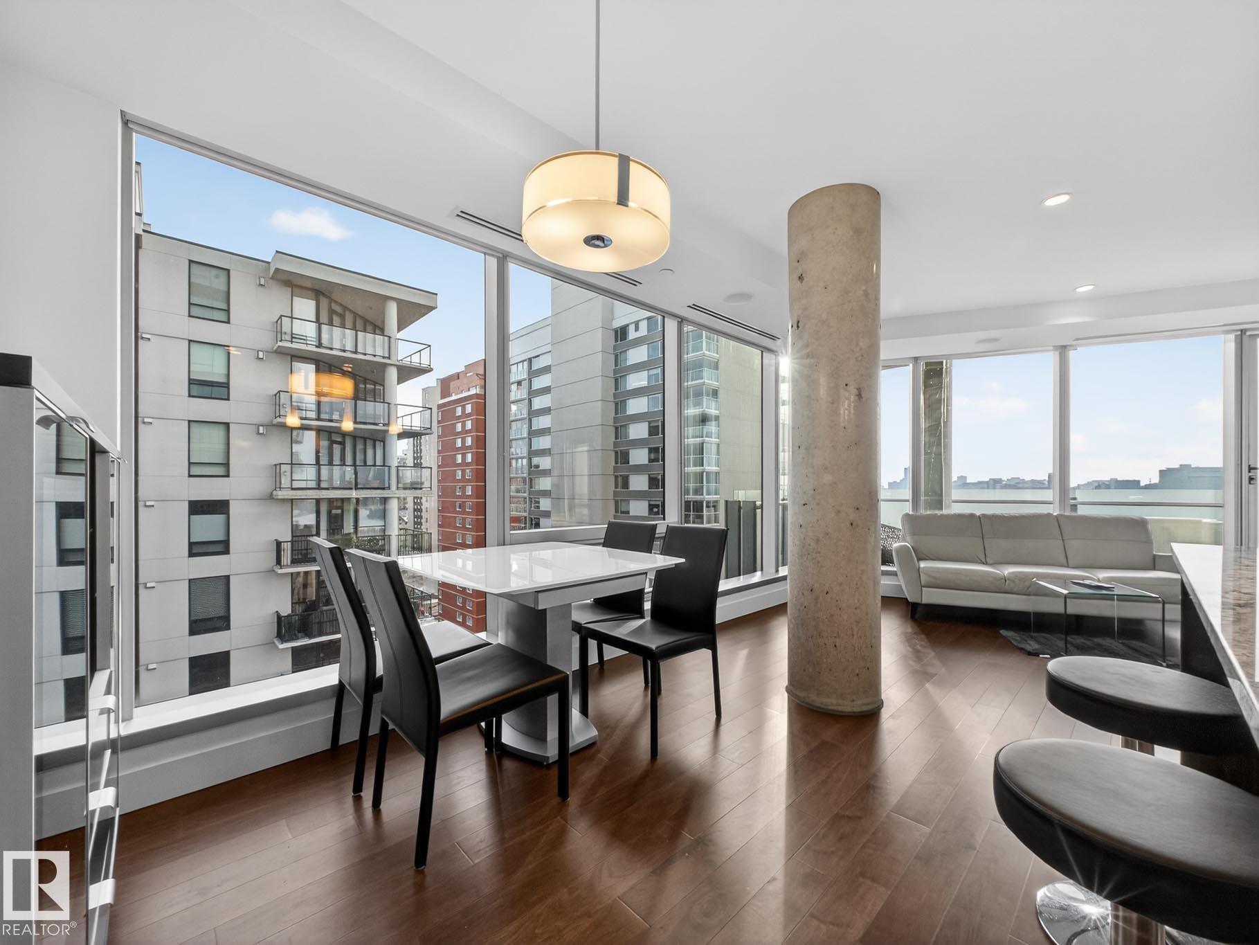 Dining space featuring dark wood-type flooring, a view of city, and recessed lighting - #902 11969 Jasper Av Nw, Edmonton, AB - Indoor Photo Showing Dining Room