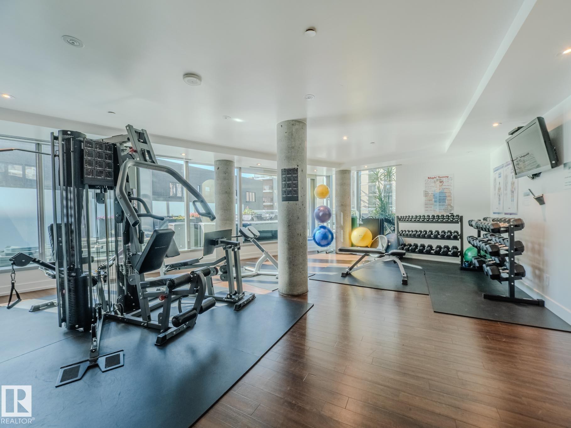 Gym featuring floor to ceiling windows and recessed lighting - #902 11969 Jasper Av Nw, Edmonton, AB - Indoor Photo Showing Gym Room
