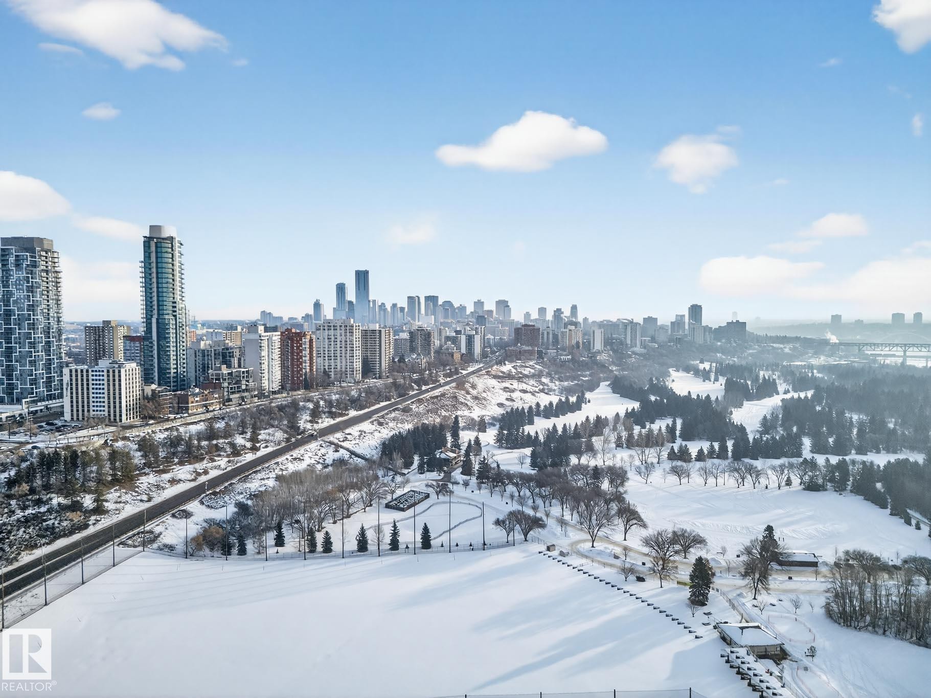 Snowy aerial view featuring a view of skyline - #902 11969 Jasper Av Nw, Edmonton, AB - Outdoor With View