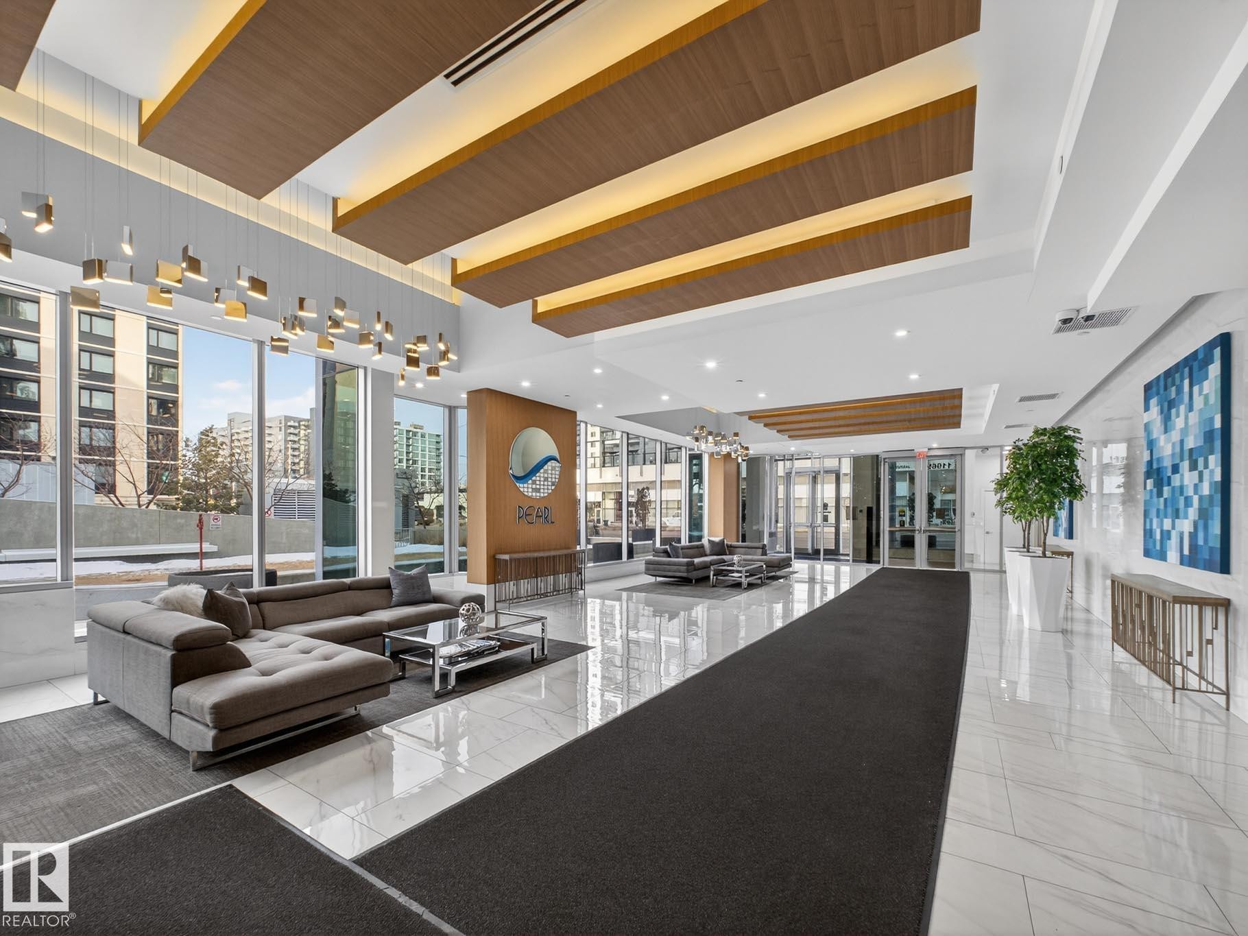 Community lobby with a view of city - #902 11969 Jasper Av Nw, Edmonton, AB - Indoor Photo Showing Other Room