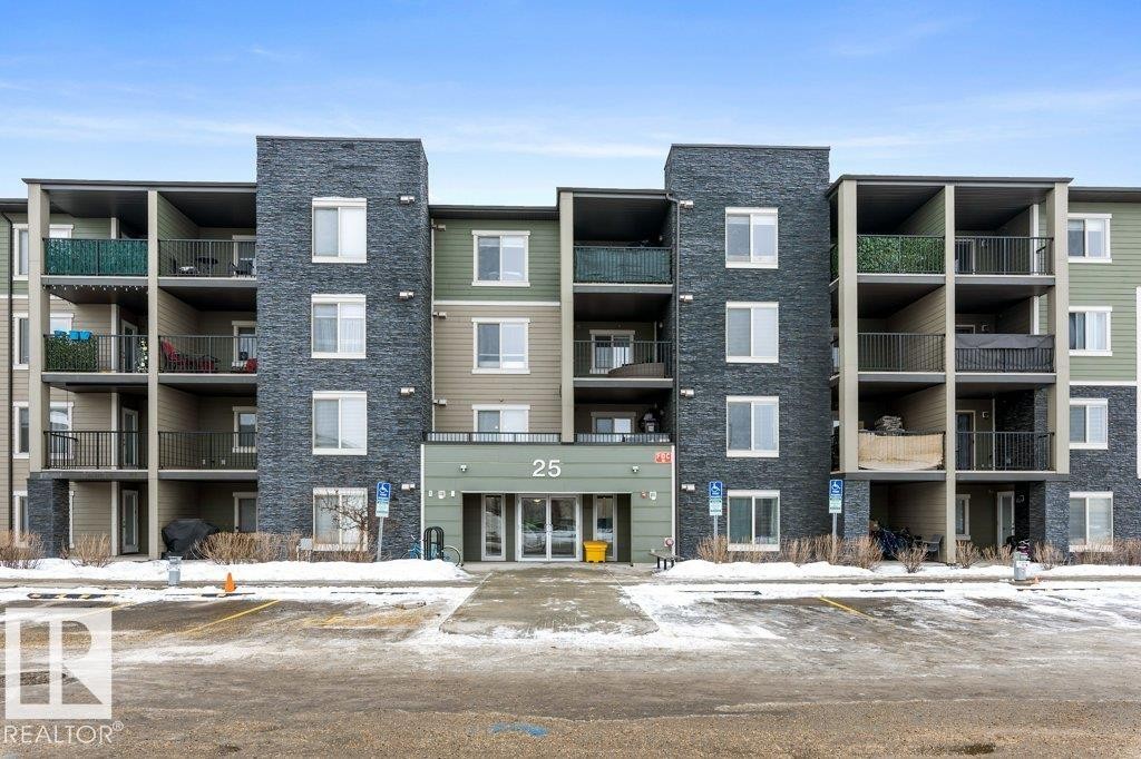 Snow covered building with a view of apartment building / complex and uncovered parking - 107 25 Element Dr, St. Albert, AB - Outdoor With Facade