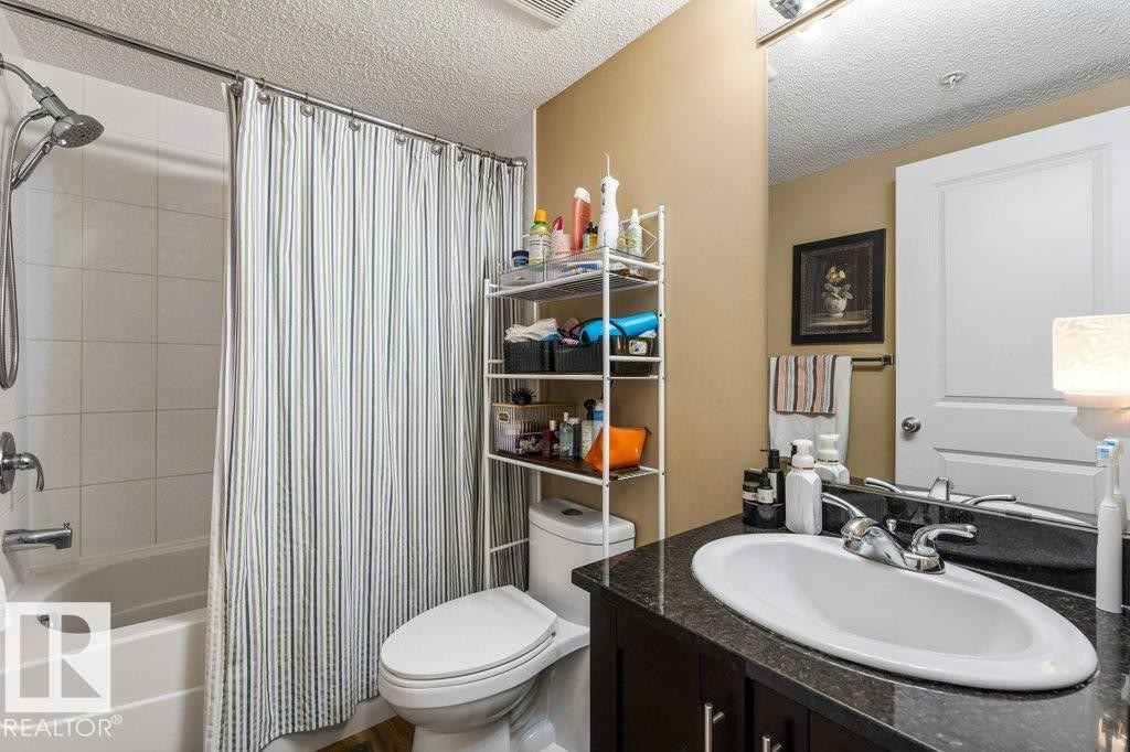Bathroom featuring shower / tub combo with curtain, vanity, and a textured ceiling - 107 25 Element Dr, St. Albert, AB - Indoor Photo Showing Bathroom