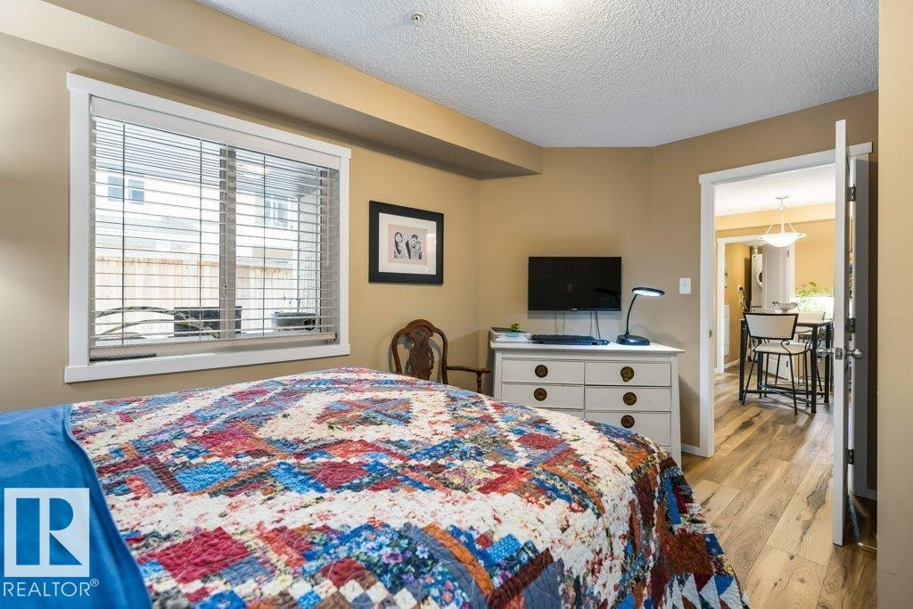 Bedroom featuring light wood-type flooring and a textured ceiling - 107 25 Element Dr, St. Albert, AB - Indoor Photo Showing Bedroom