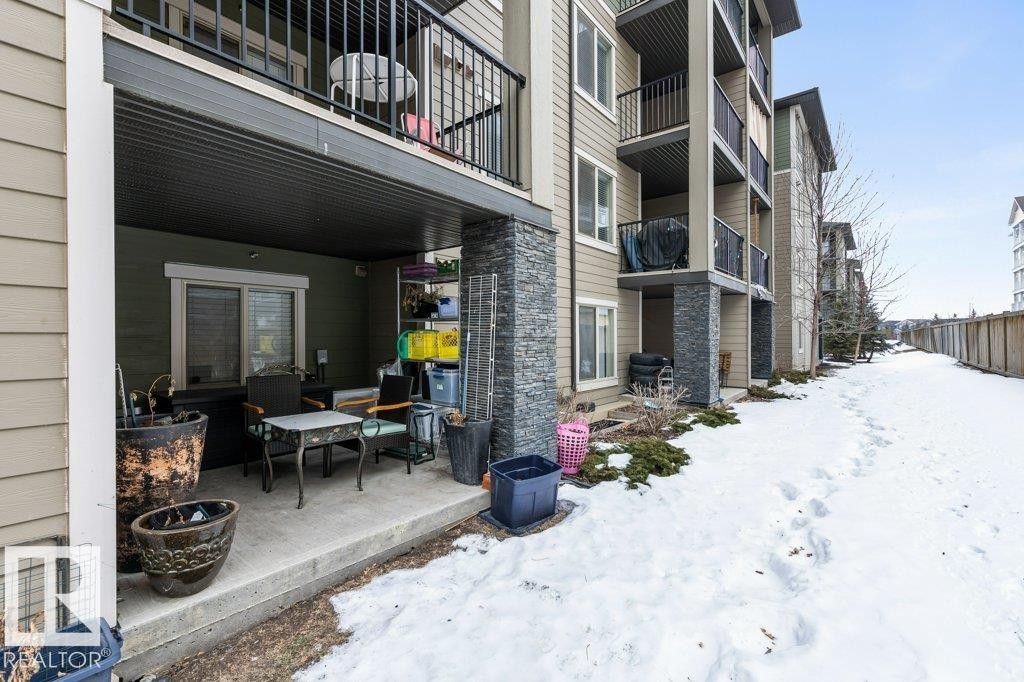 Snow covered patio featuring a patio and a grill - 107 25 Element Dr, St. Albert, AB - Outdoor With Exterior