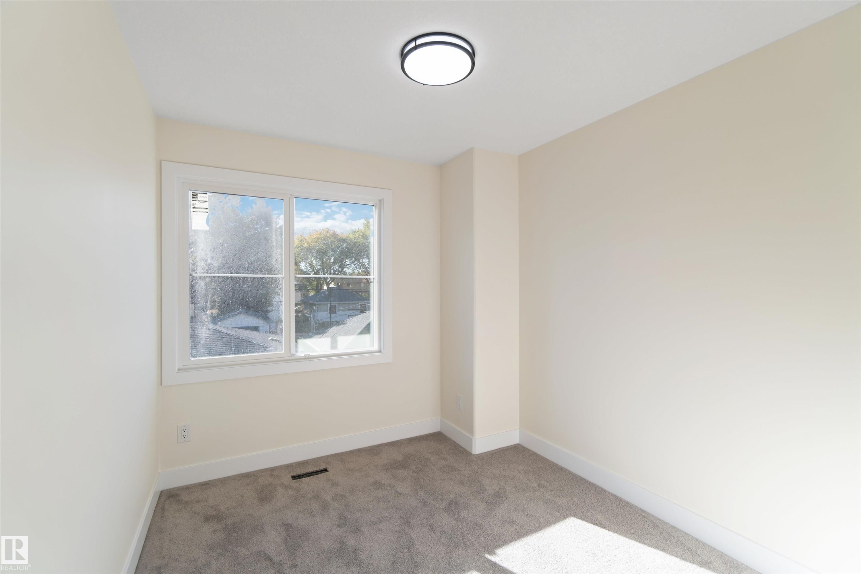 bedroom 3 9'6"x8'6" with walk in closet! - 8319 81Ave, Edmonton, AB - Indoor Photo Showing Other Room