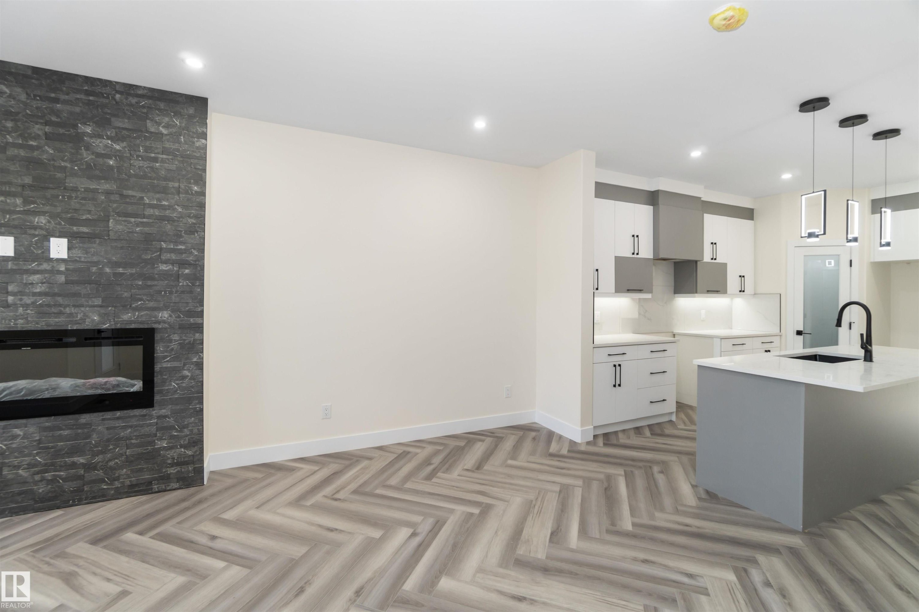 Quartz countertops and high end finishing define the kitchen - 8319 81Ave, Edmonton, AB - Indoor Photo Showing Kitchen With Upgraded Kitchen