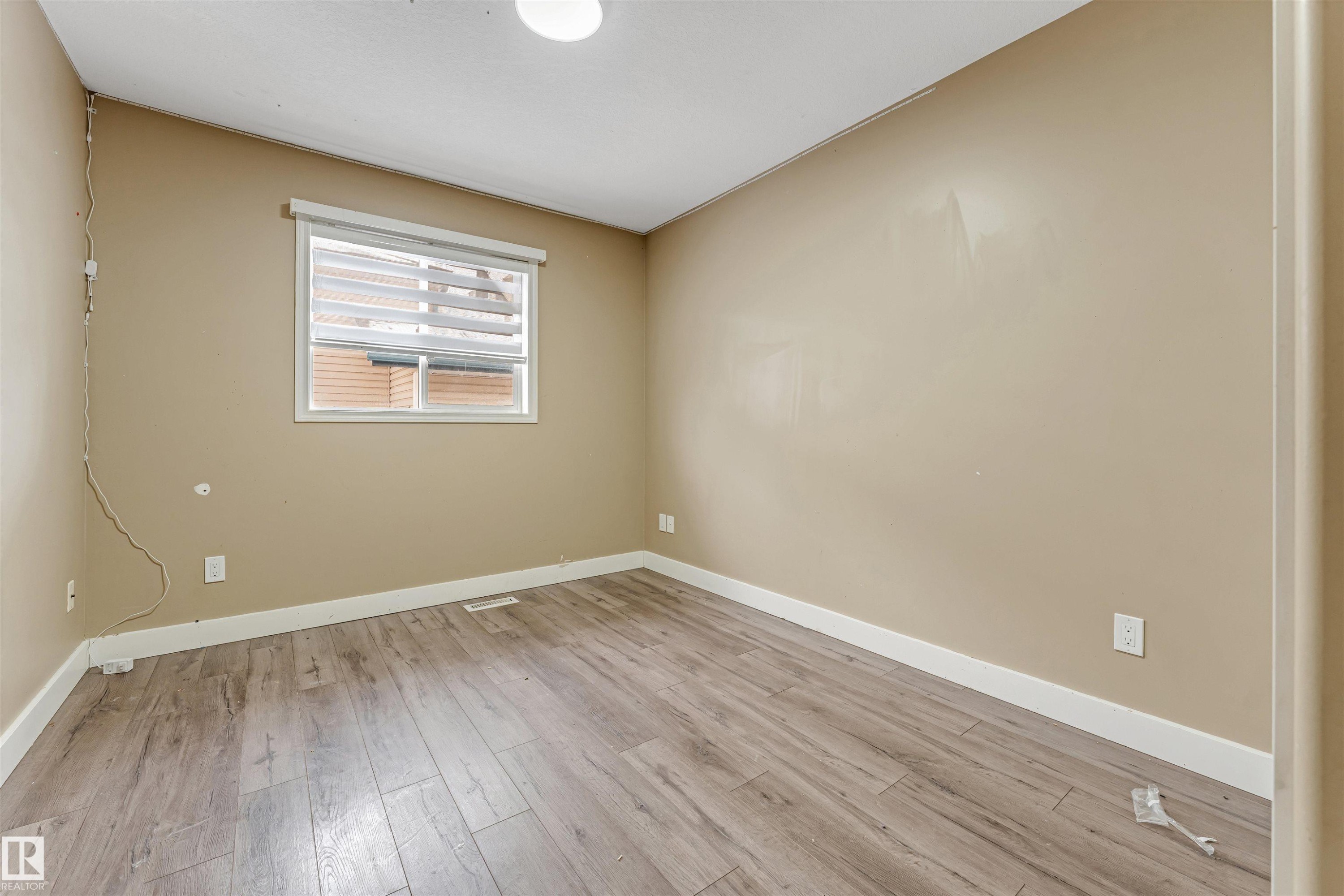 Empty room featuring baseboards and light wood-type flooring - 6741 162A Avenue, Edmonton, AB - Indoor Photo Showing Other Room