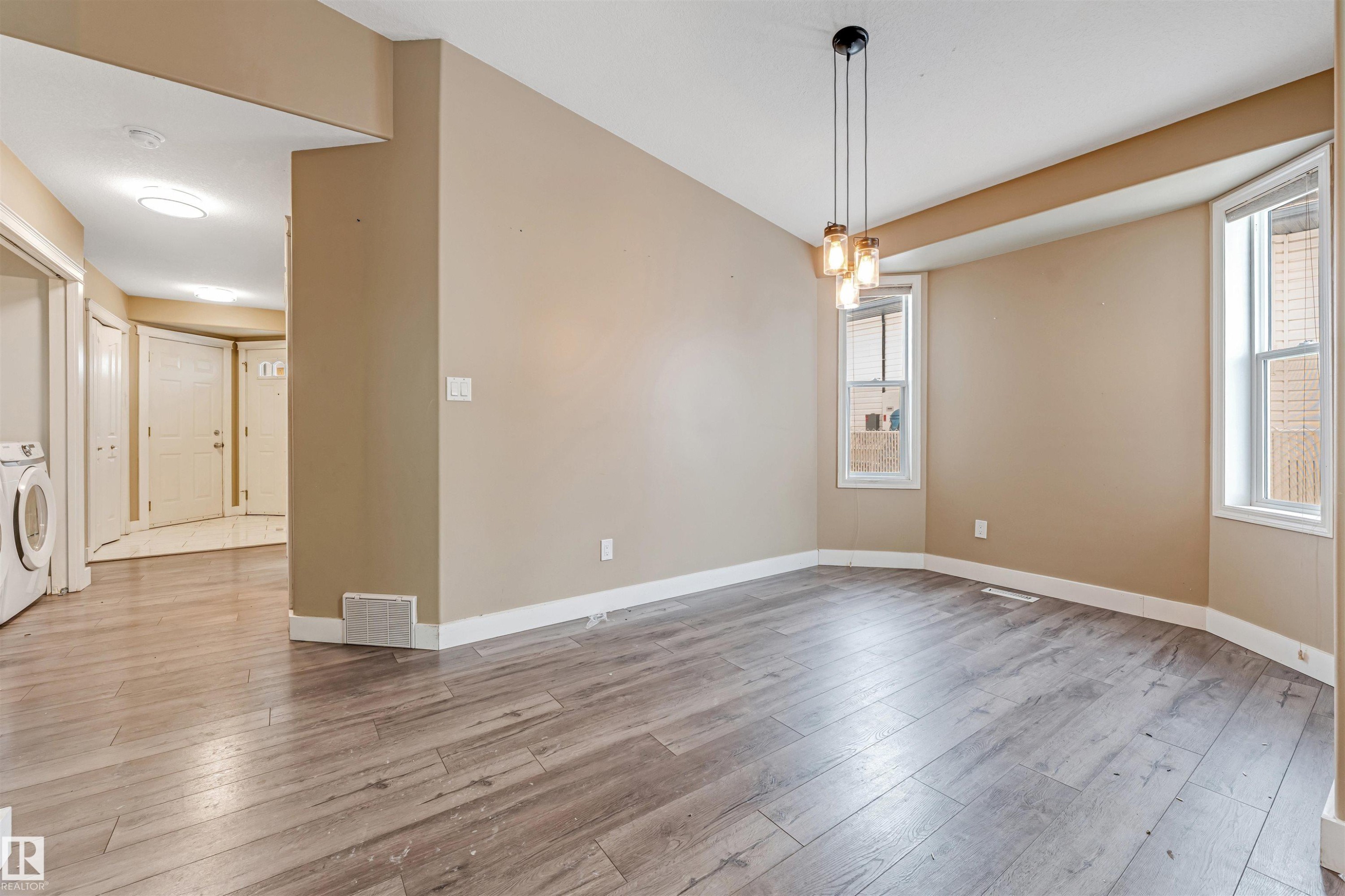 Spare room featuring light wood finished floors and washer / dryer - 6741 162A Avenue, Edmonton, AB - Indoor Photo Showing Other Room