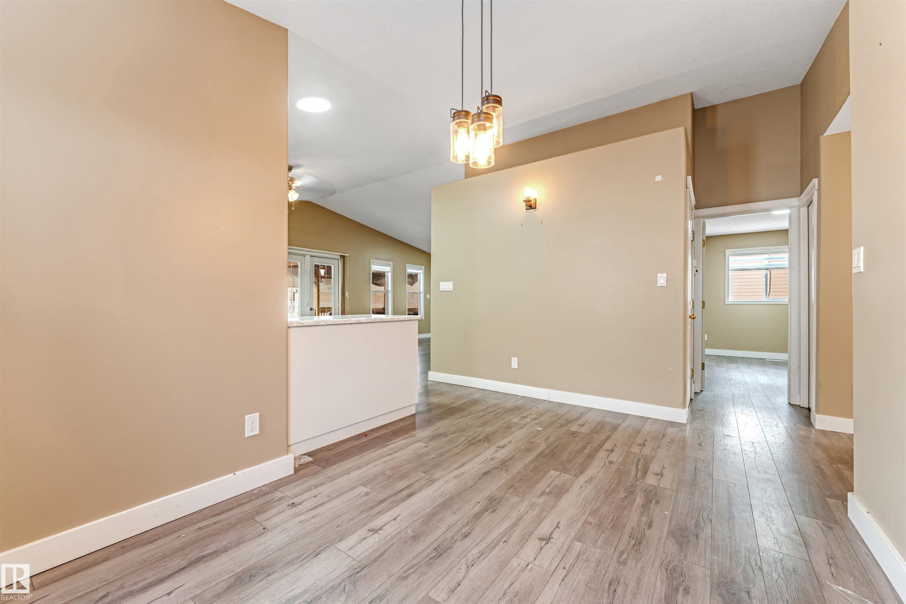 Unfurnished room featuring light wood-style floors, a chandelier, vaulted ceiling, and recessed lighting - 6741 162A Avenue, Edmonton, AB - Indoor Photo Showing Other Room