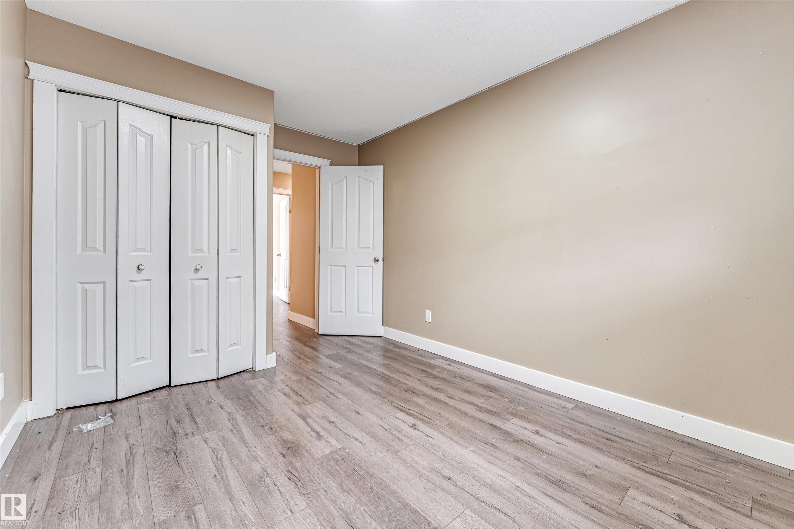 Unfurnished bedroom featuring a closet and light wood-style flooring - 6741 162A Avenue, Edmonton, AB - Indoor Photo Showing Other Room
