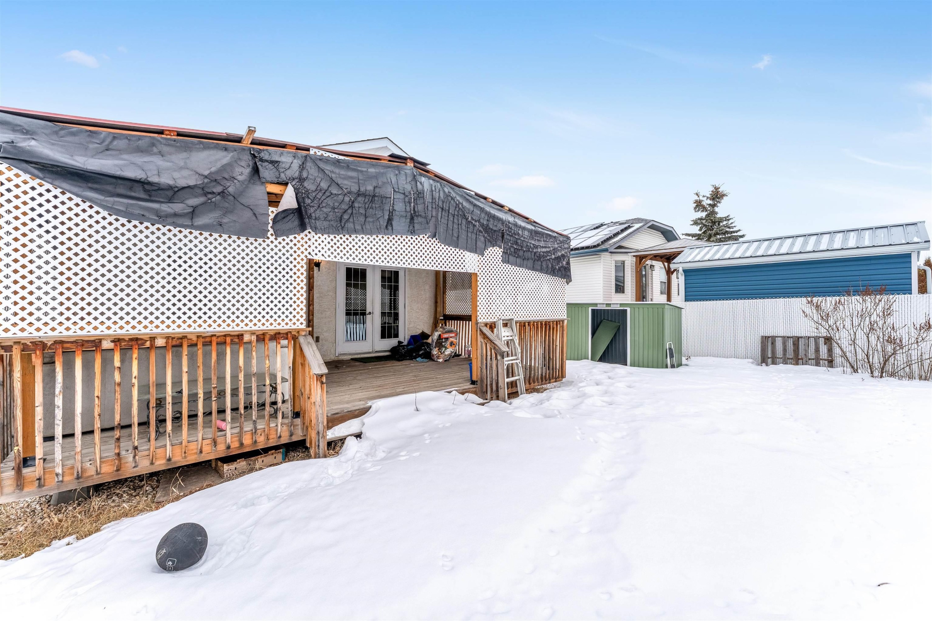 Snow covered rear of property featuring a deck and french doors - 6741 162A Avenue, Edmonton, AB - Outdoor