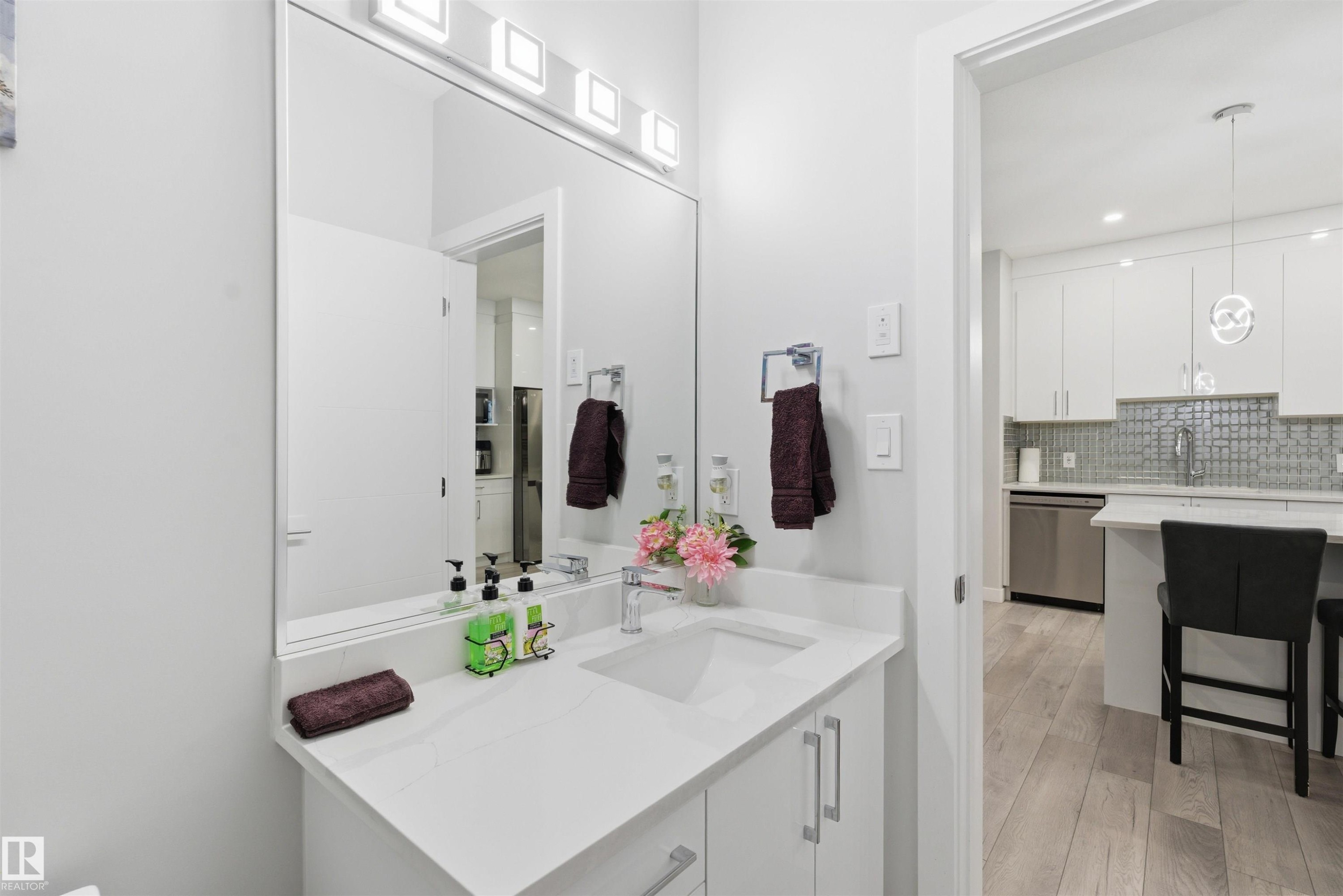 Bathroom featuring vanity, light wood finished floors, decorative backsplash, and recessed lighting - 452 Roberts Crescent, Leduc, AB - Indoor