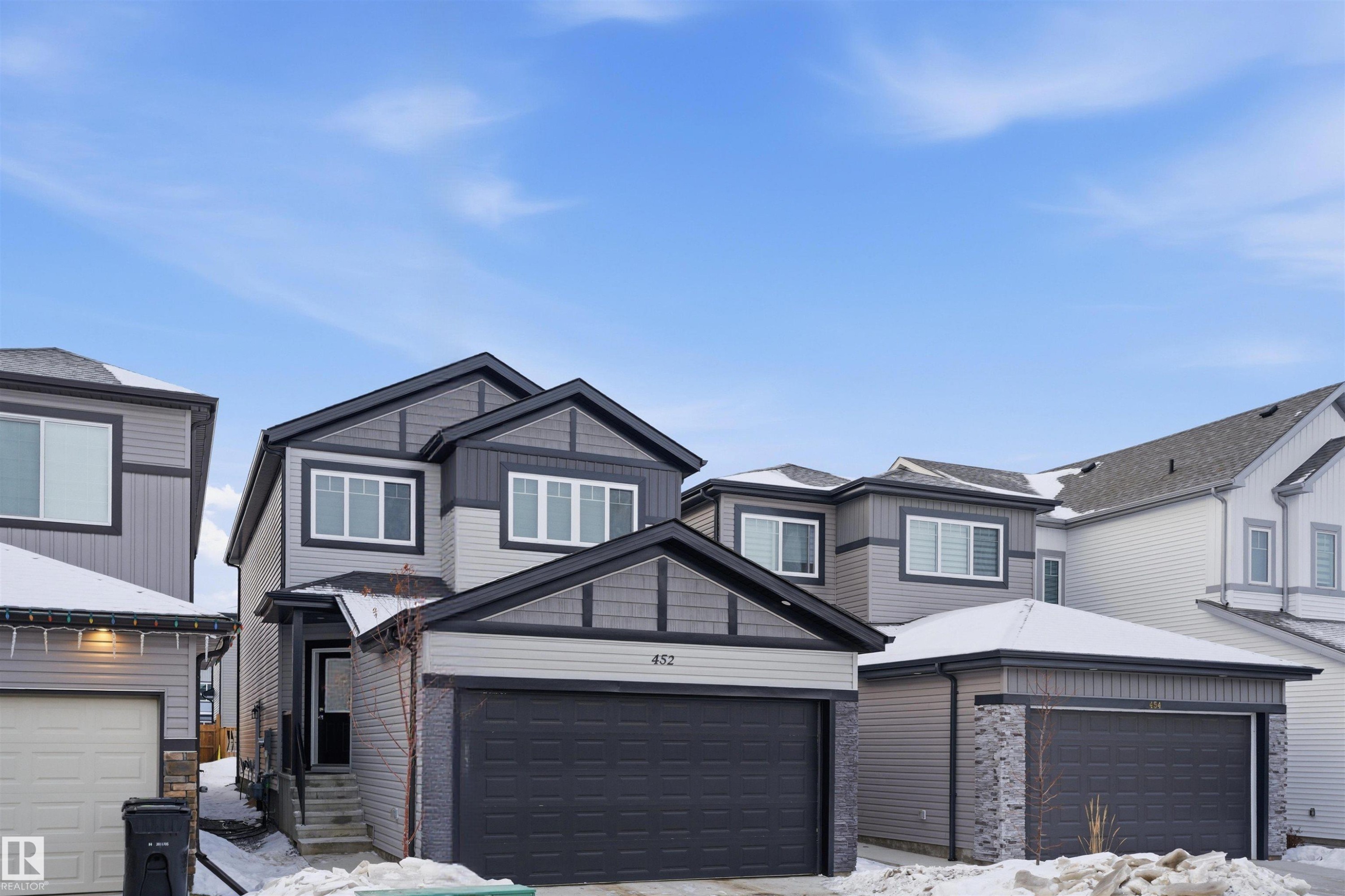 View of front of home featuring a garage and board and batten siding - 452 Roberts Crescent, Leduc, AB - Outdoor With Facade