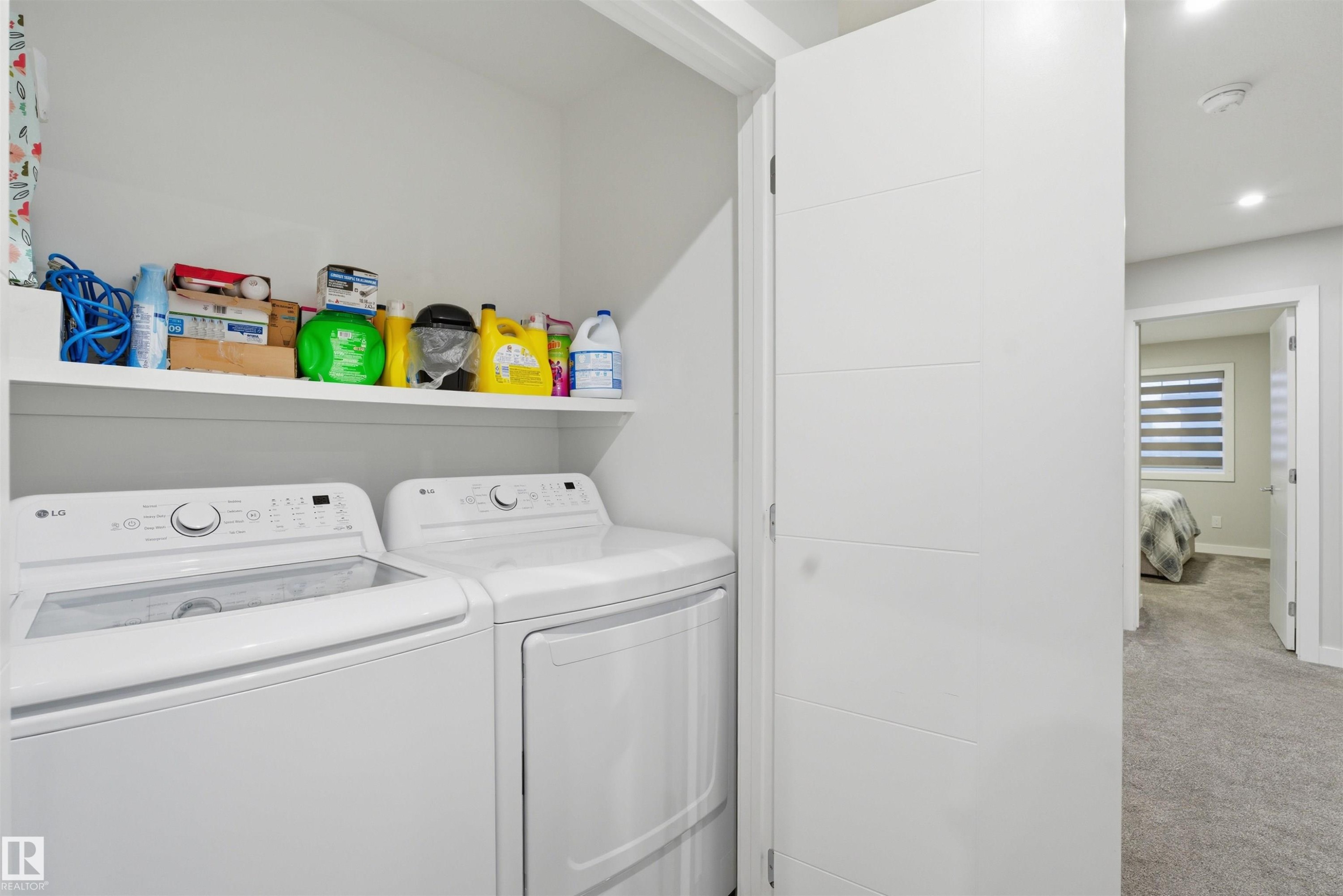 Laundry room with washer and dryer, carpet floors, and recessed lighting - 452 Roberts Crescent, Leduc, AB - Indoor Photo Showing Laundry Room