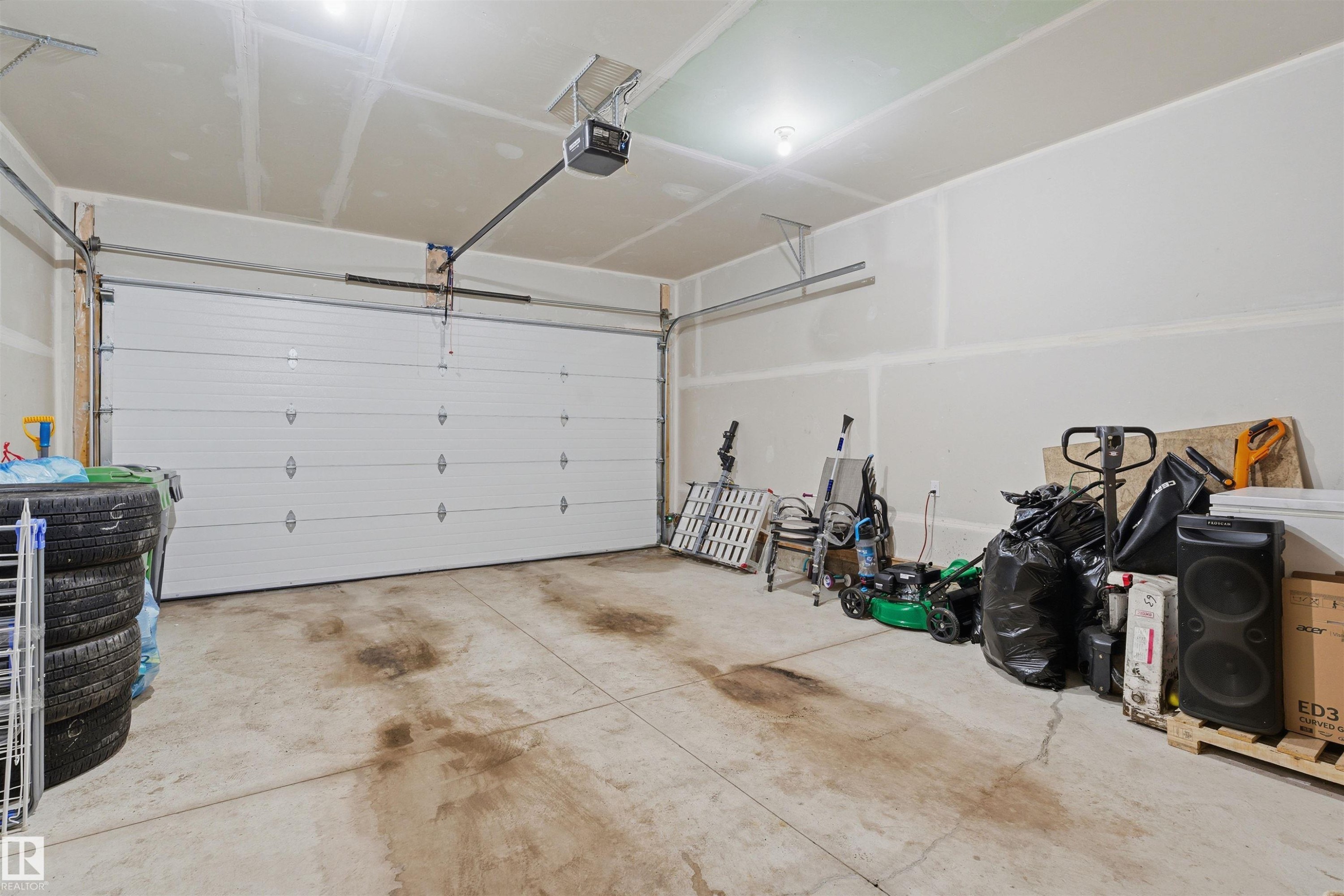 Garage with a garage door opener - 452 Roberts Crescent, Leduc, AB - Indoor Photo Showing Garage