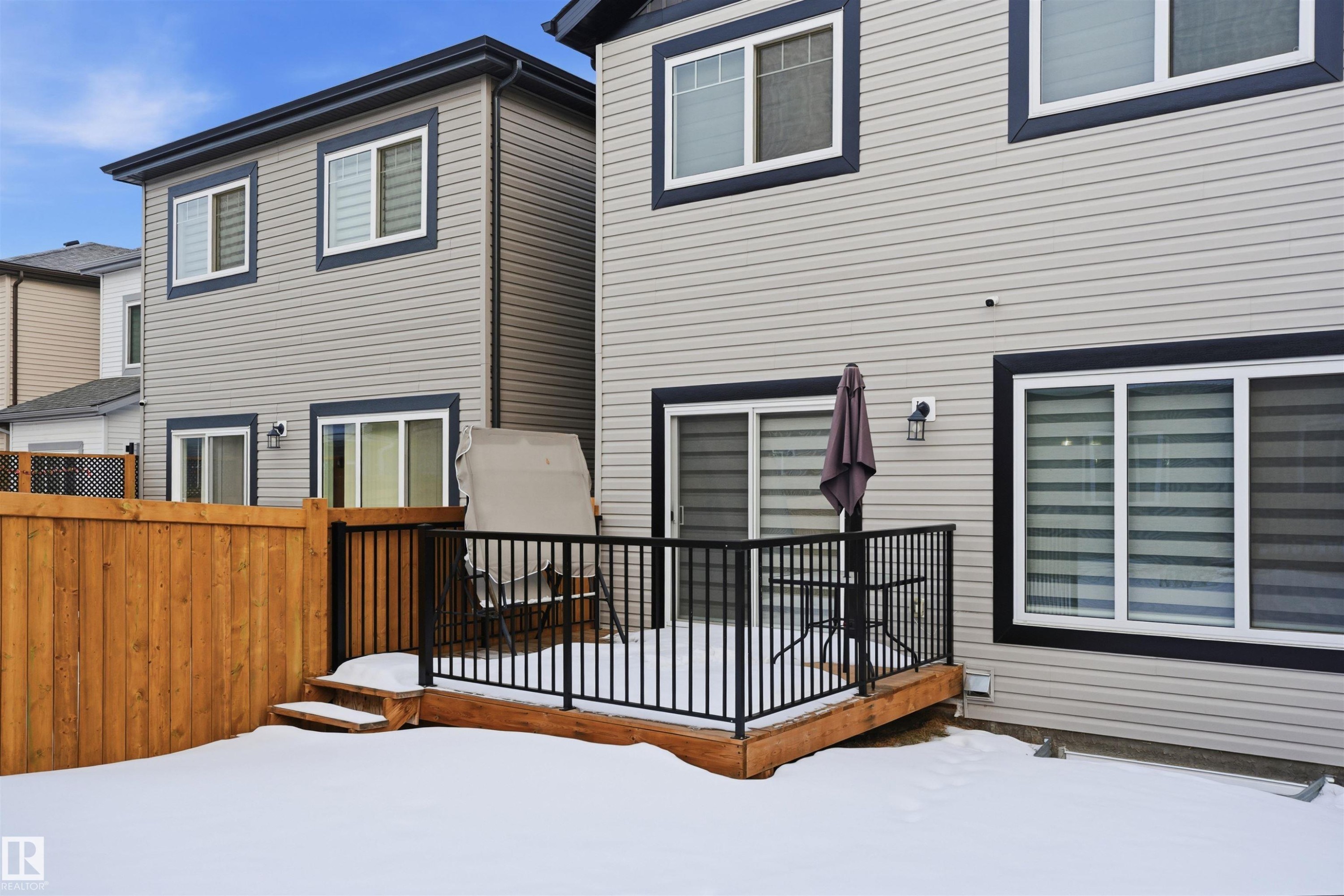 Snow covered rear of property with a wooden deck - 452 Roberts Crescent, Leduc, AB - Outdoor With Exterior