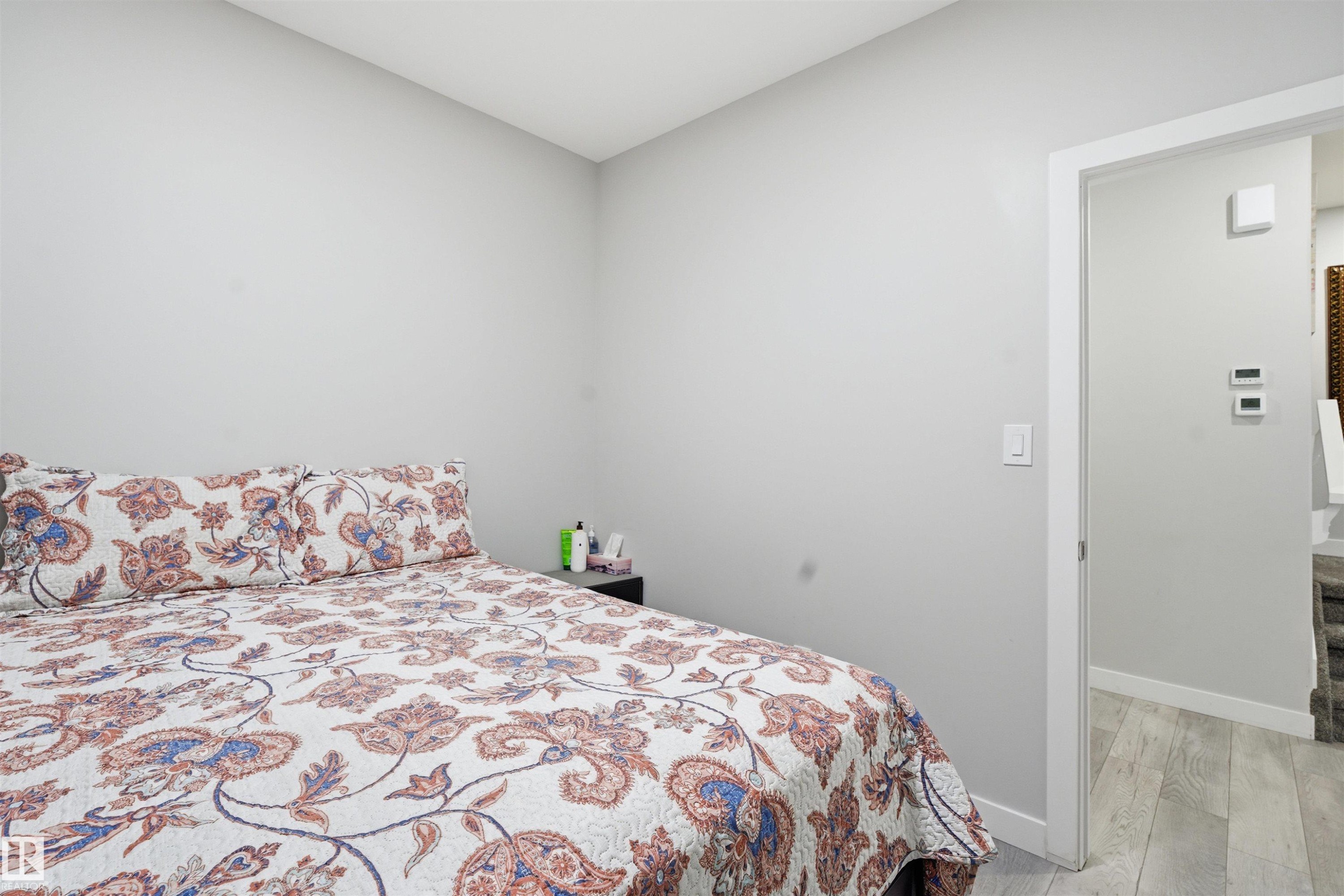 Bedroom with light wood finished floors and baseboards - 452 Roberts Crescent, Leduc, AB - Indoor Photo Showing Bedroom