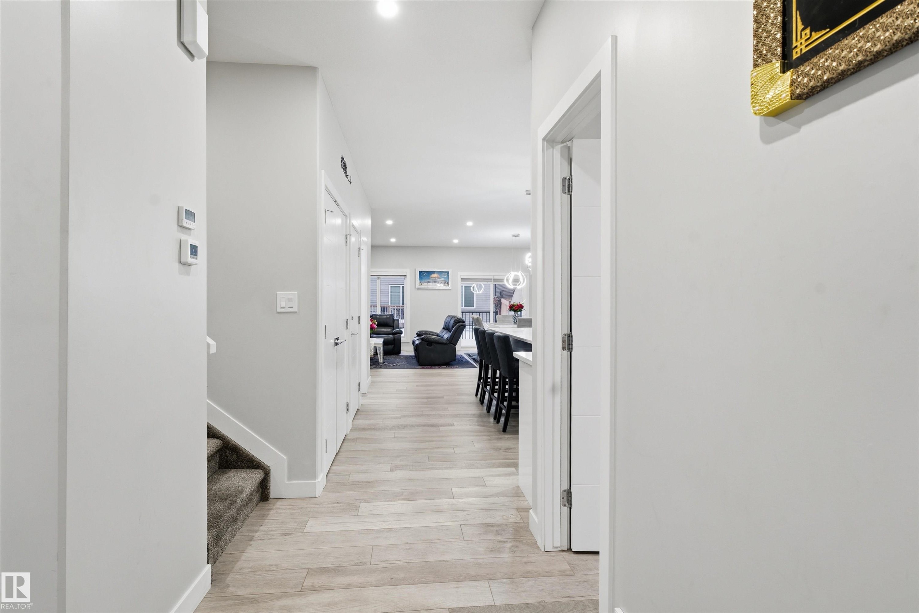 Hallway featuring recessed lighting, light wood finished floors, and stairway - 452 Roberts Crescent, Leduc, AB - Indoor Photo Showing Other Room