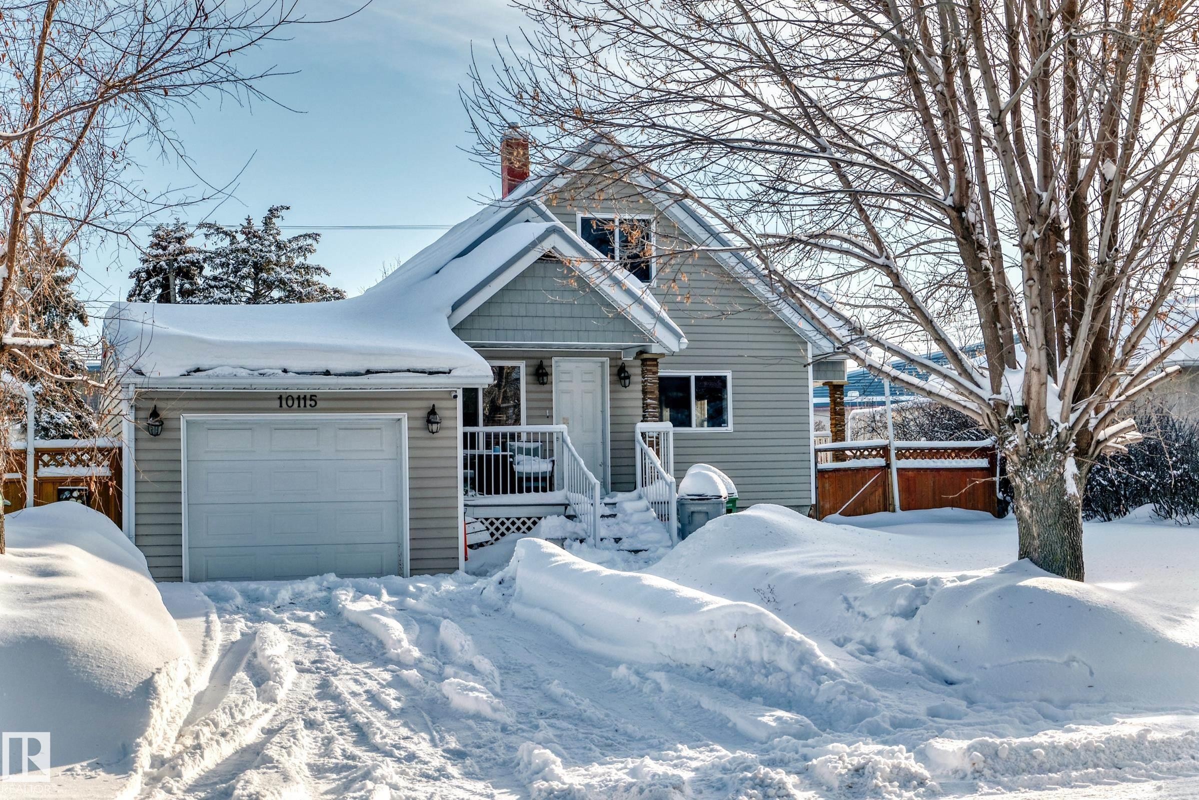 View of front facade with a chimney and a garage - 10115 104, Westlock, AB - Outdoor