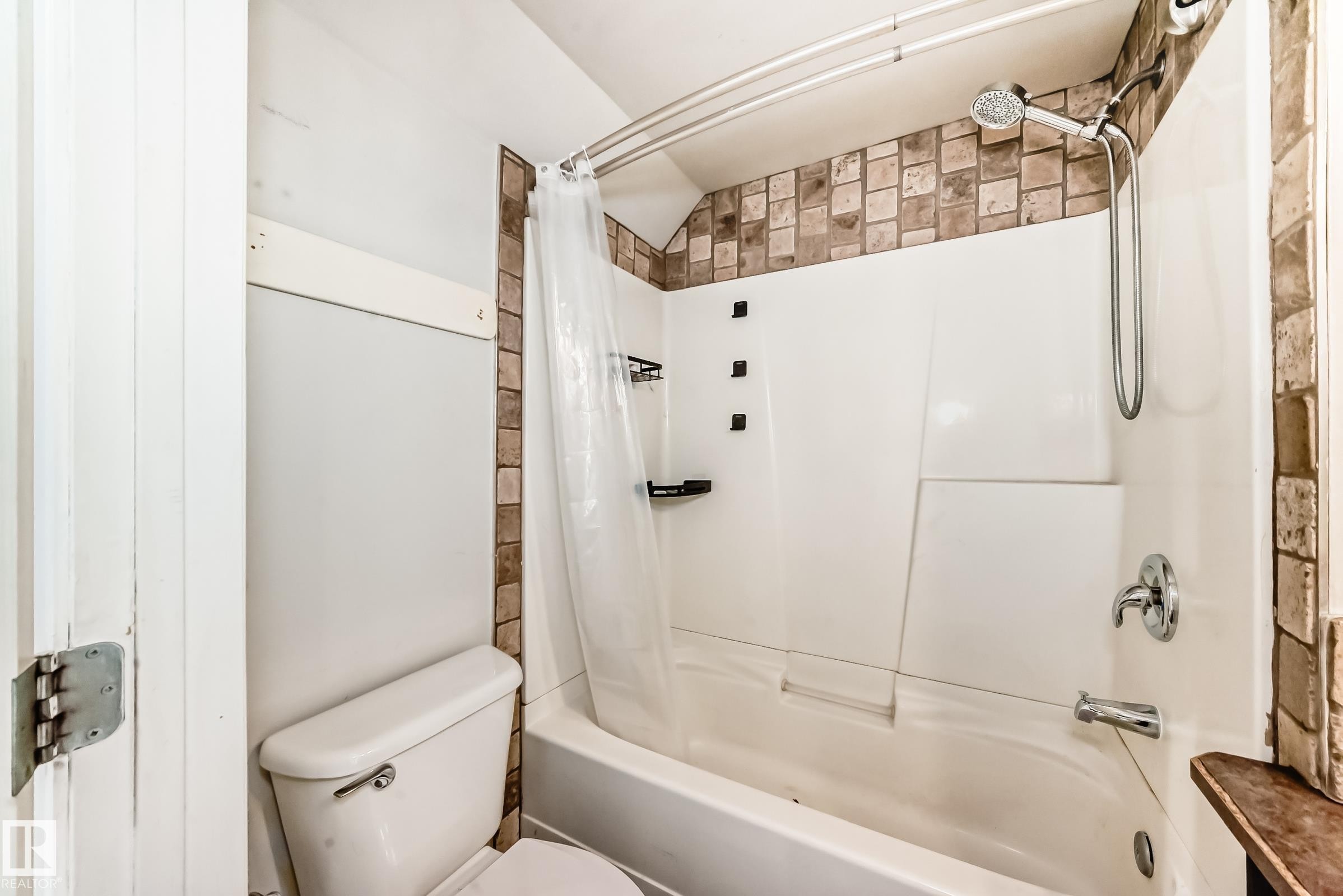 Full bathroom featuring shower / tub combo with curtain and toilet - 10115 104, Westlock, AB - Indoor Photo Showing Bathroom