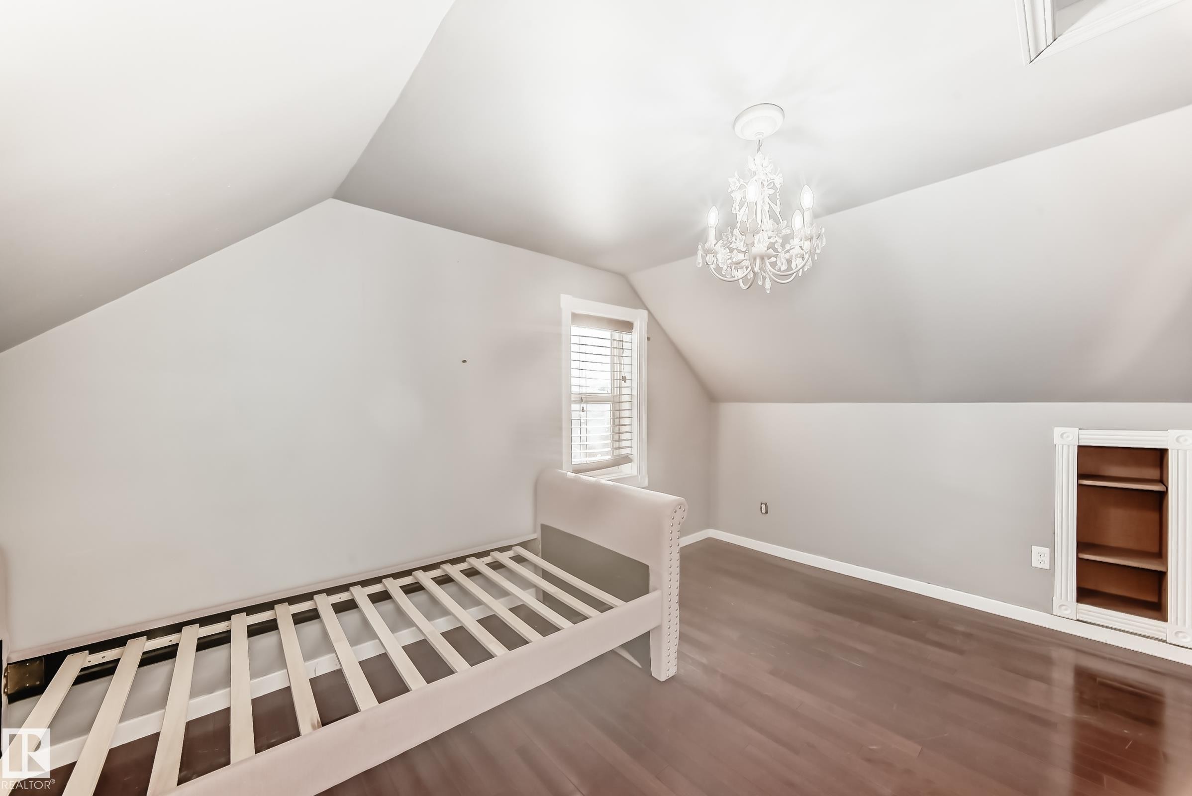 Additional living space featuring vaulted ceiling, dark wood finished floors, and a chandelier - 10115 104, Westlock, AB - Indoor Photo Showing Other Room